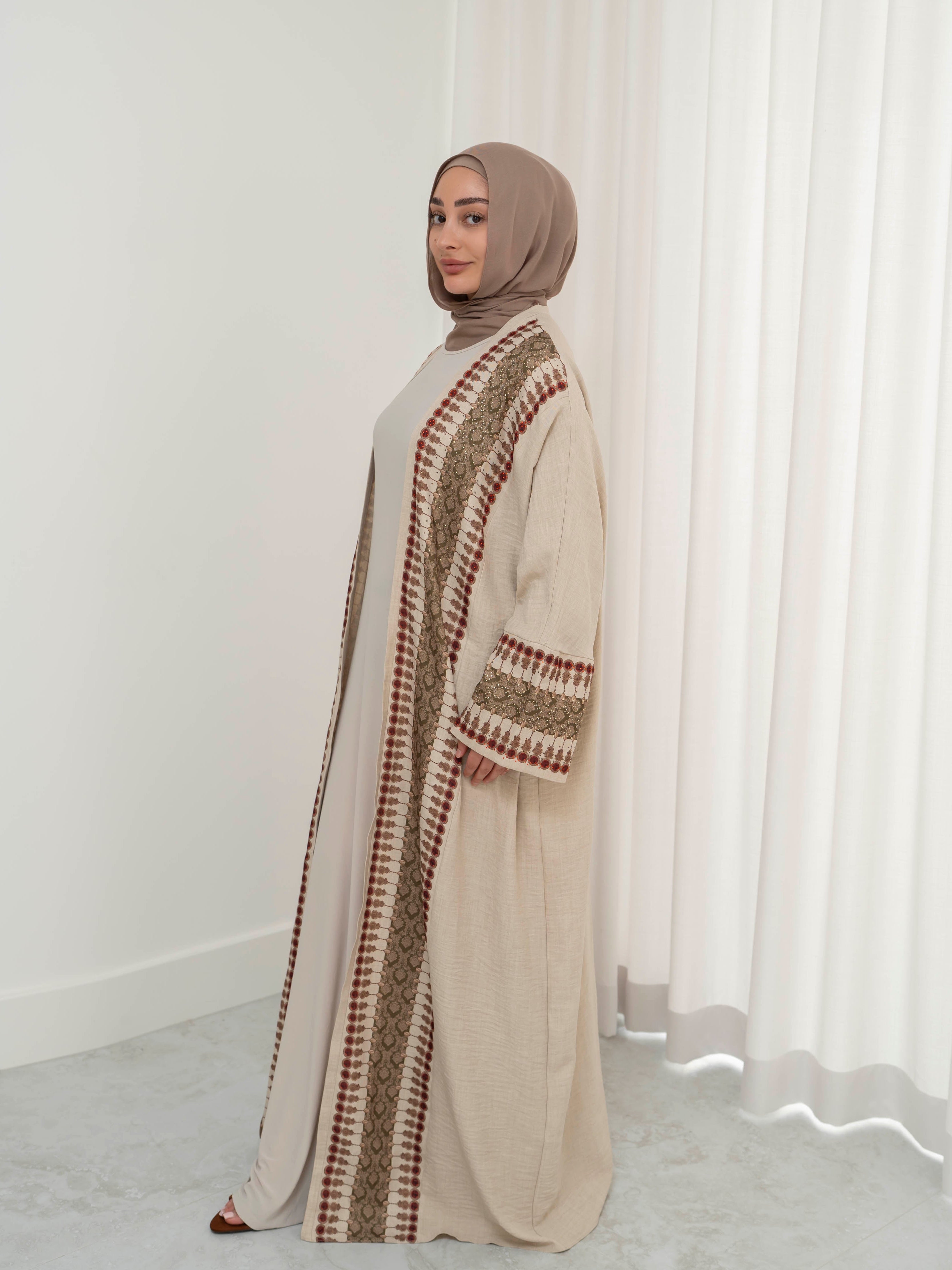 Model wearing the Andalus open abaya with an intricate patterned fabric and subtle embellishments, styled open for a modest and elegant look suitable for Ramadan and Eid.