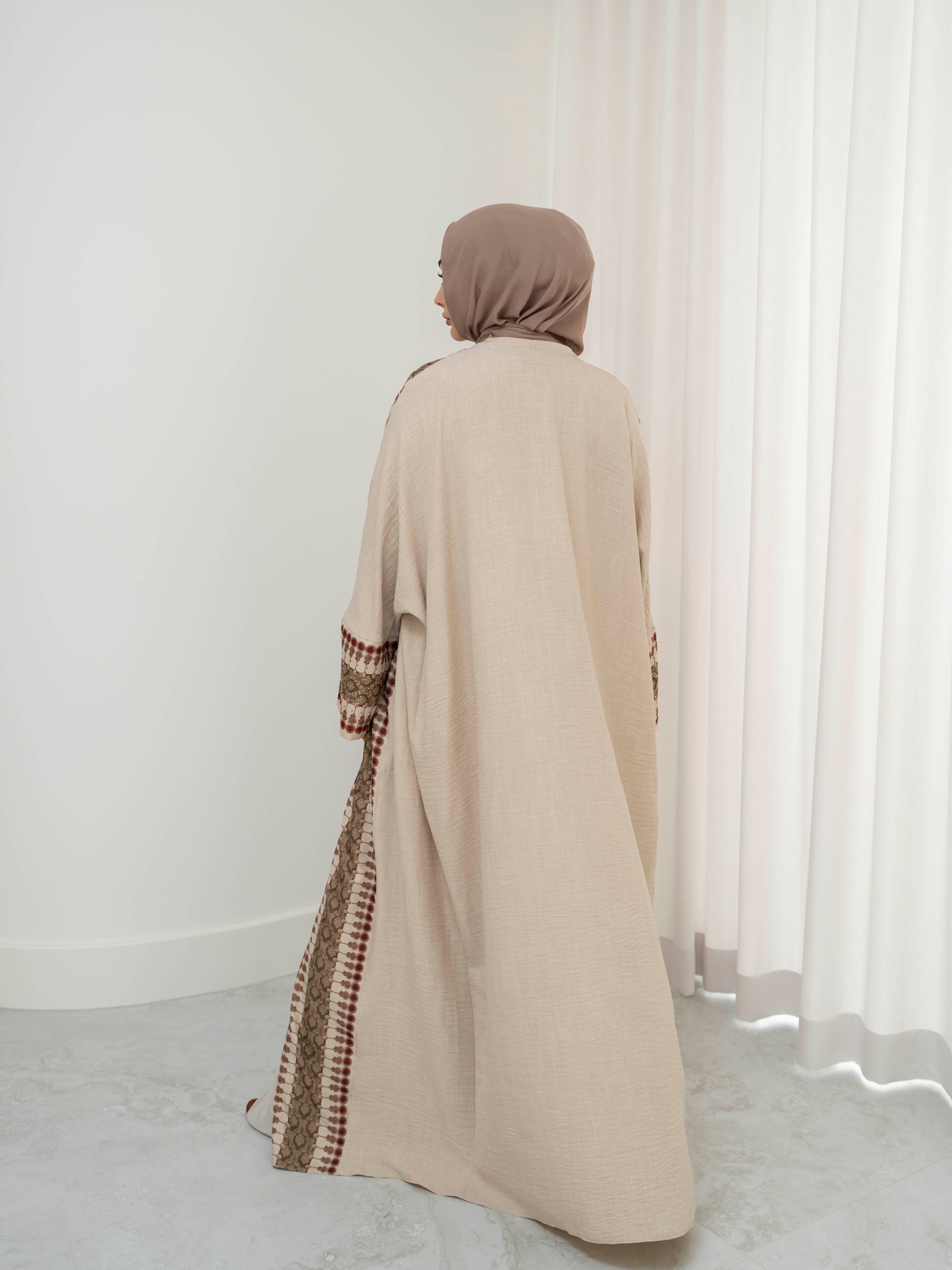 Model wearing the Andalus open abaya with an intricate patterned fabric and subtle embellishments, styled open for a modest and elegant look suitable for Ramadan and Eid.