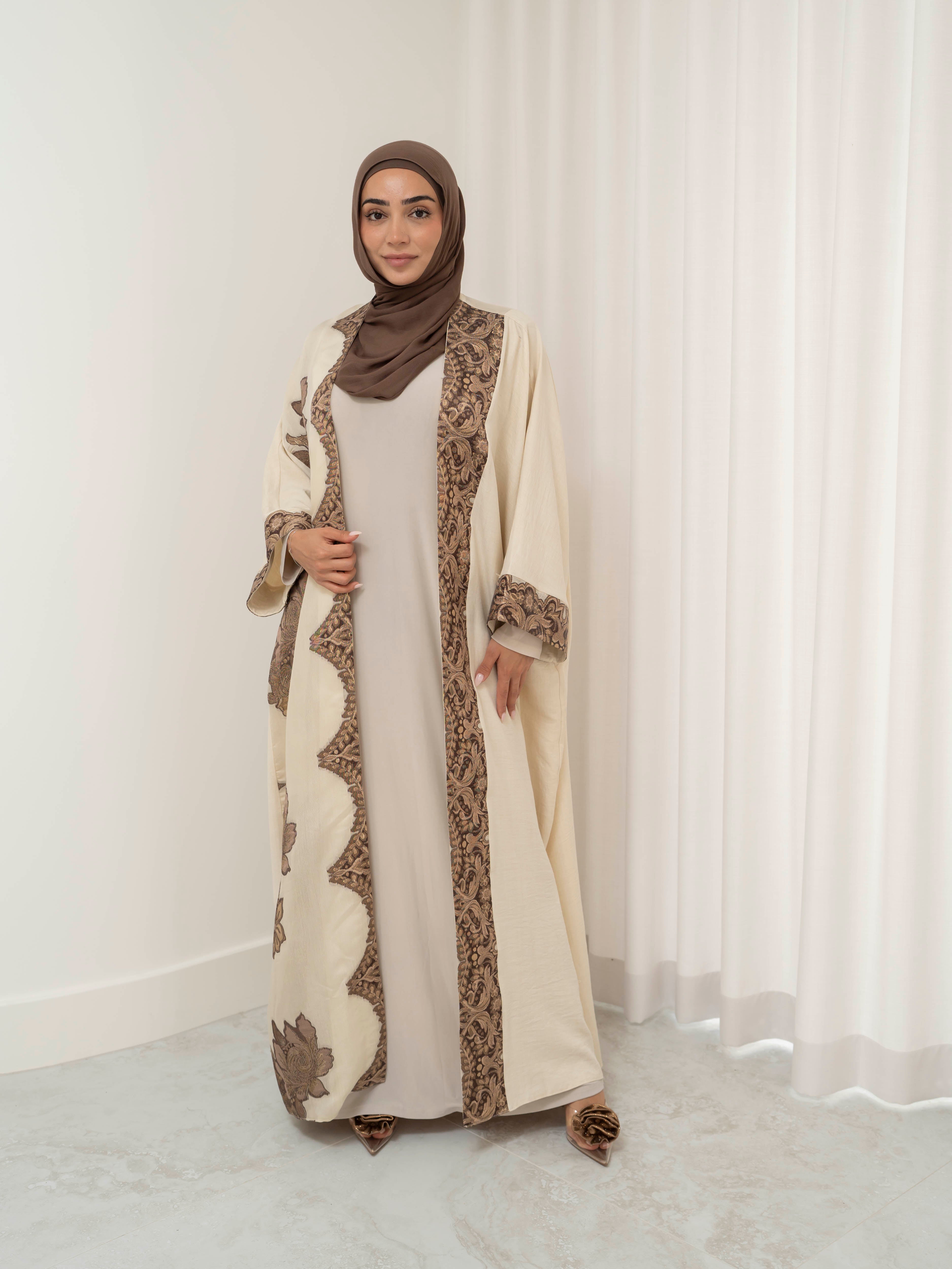 Model wearing the Heritage Luxe open abaya featuring an elegant open-front silhouette with refined detailing, styled for a modest and luxurious look suitable for Ramadan and Eid.