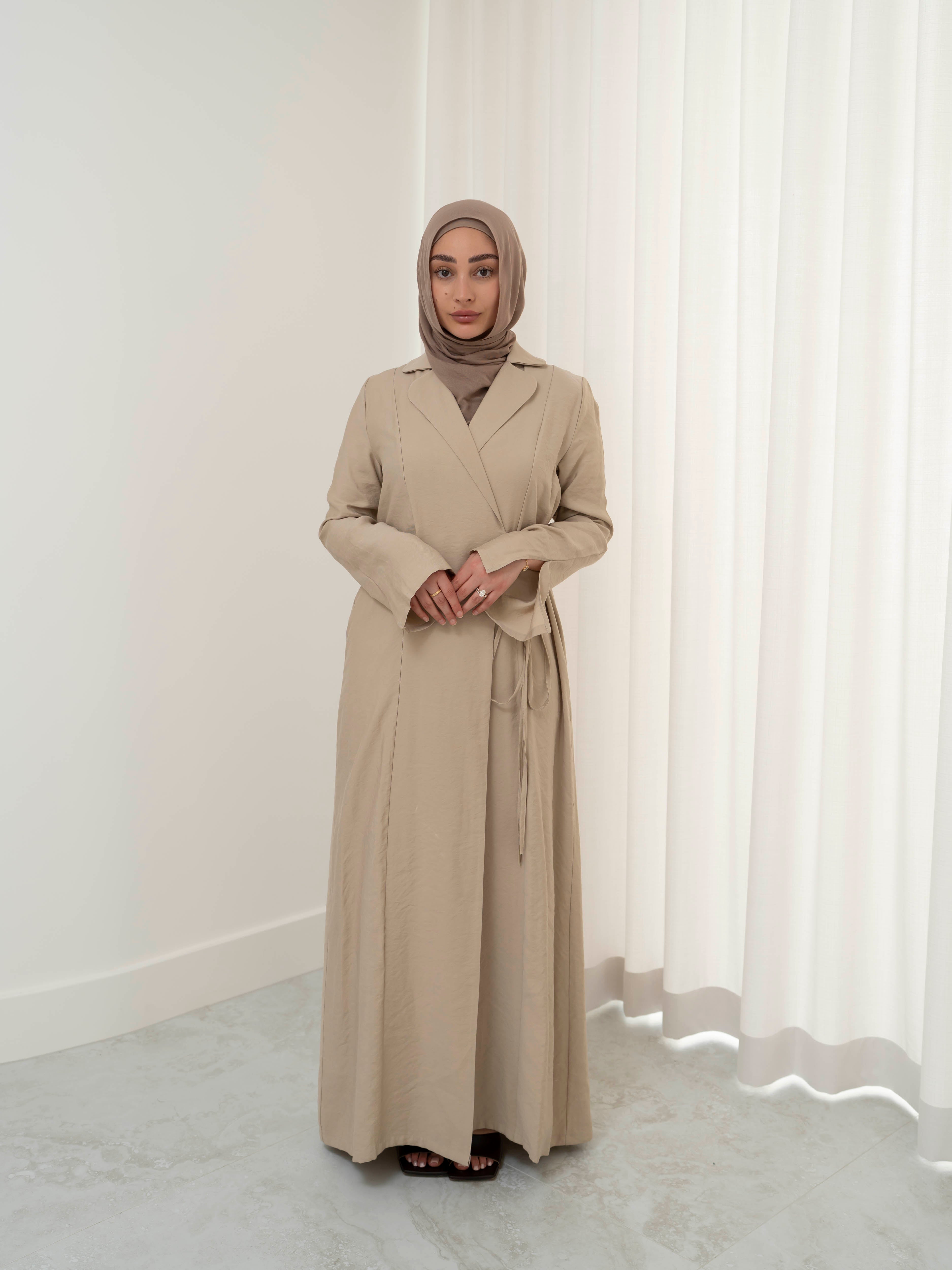 Alya Tie Dress, a full-length dress with adjustable waist tie, lapel neckline, and long sleeves with cuff finish. Lightweight fabric with soft drape, offering a modest, elegant silhouette for Eid, formal occasions, or refined everyday wear.