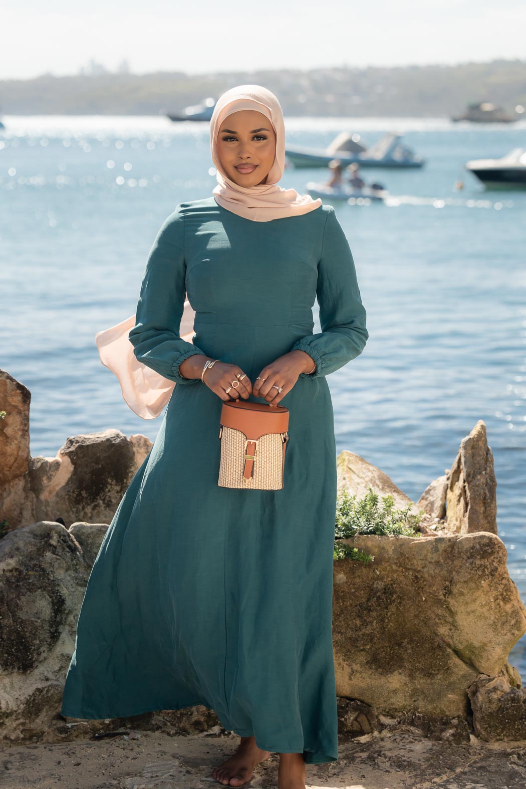 Amira Linen Dress in a soft linen-blend fabric with long sleeves and a fitted bodice featuring limited stretch. Designed with an empire waist that flows into a loose high-low skirt for an elegant, flattering silhouette suitable for special occasions.