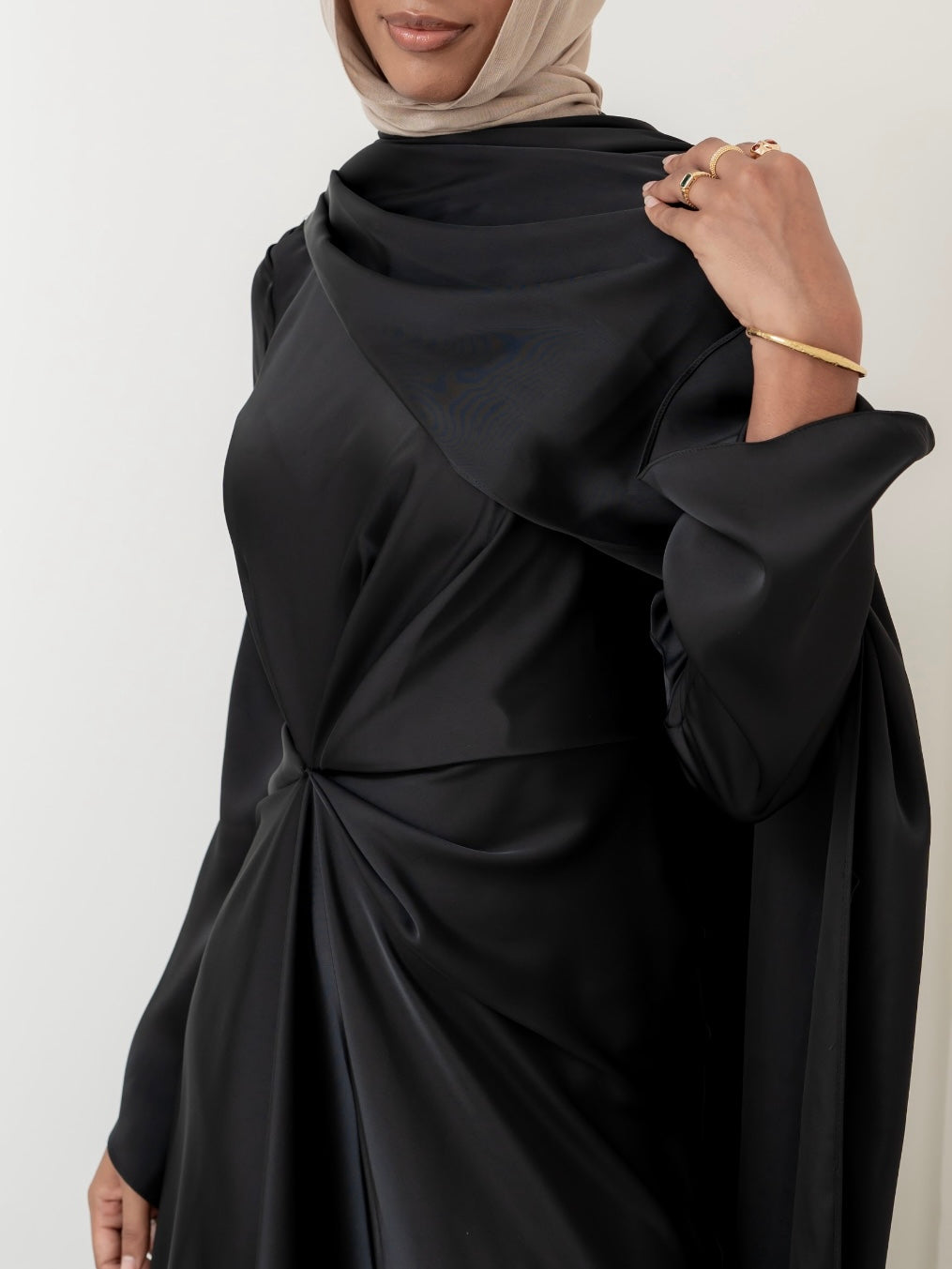 Aurora Drape Formal Dress with draped waist design and A-line silhouette for a flattering, flowing fit. Features draped sleeves, floor-length maxi style, and soft luxurious fabric. Available in Black, Brown, Vanilla, and Taupe — ideal for weddings, galas, and formal evening events.