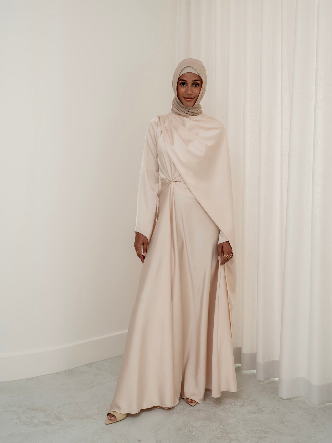 Step into effortless elegance with the Aurora Drape Formal Dress. This stunning piece features an expertly crafted draped design that gathers beautifully at the waist, accentuating your figure while creating a graceful, flowing silhouette. 