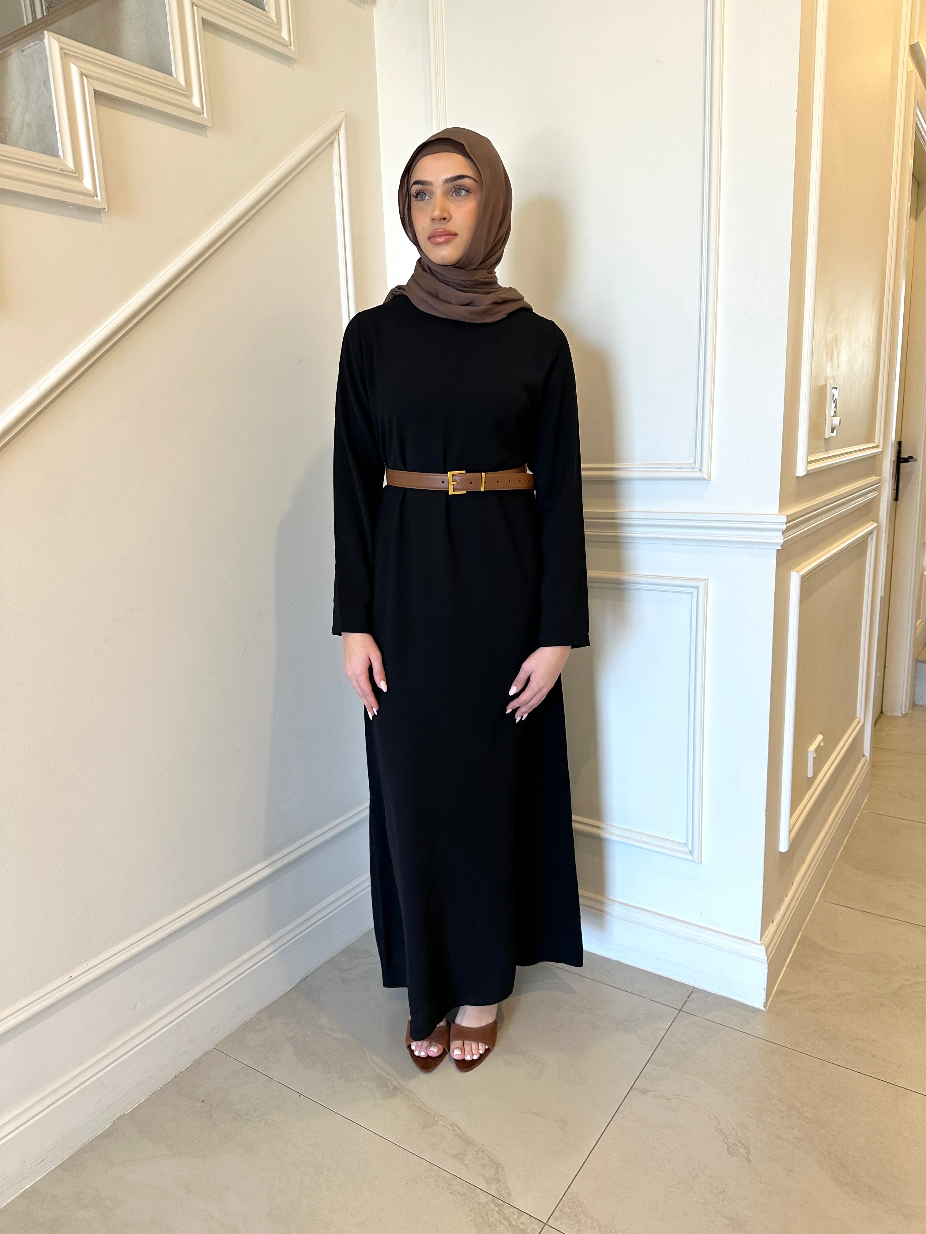 Basic Abaya in a classic straight-cut maxi silhouette with long sleeves and a round neckline. Minimalist design offers modest, polished elegance suitable for everyday wear or special occasions.