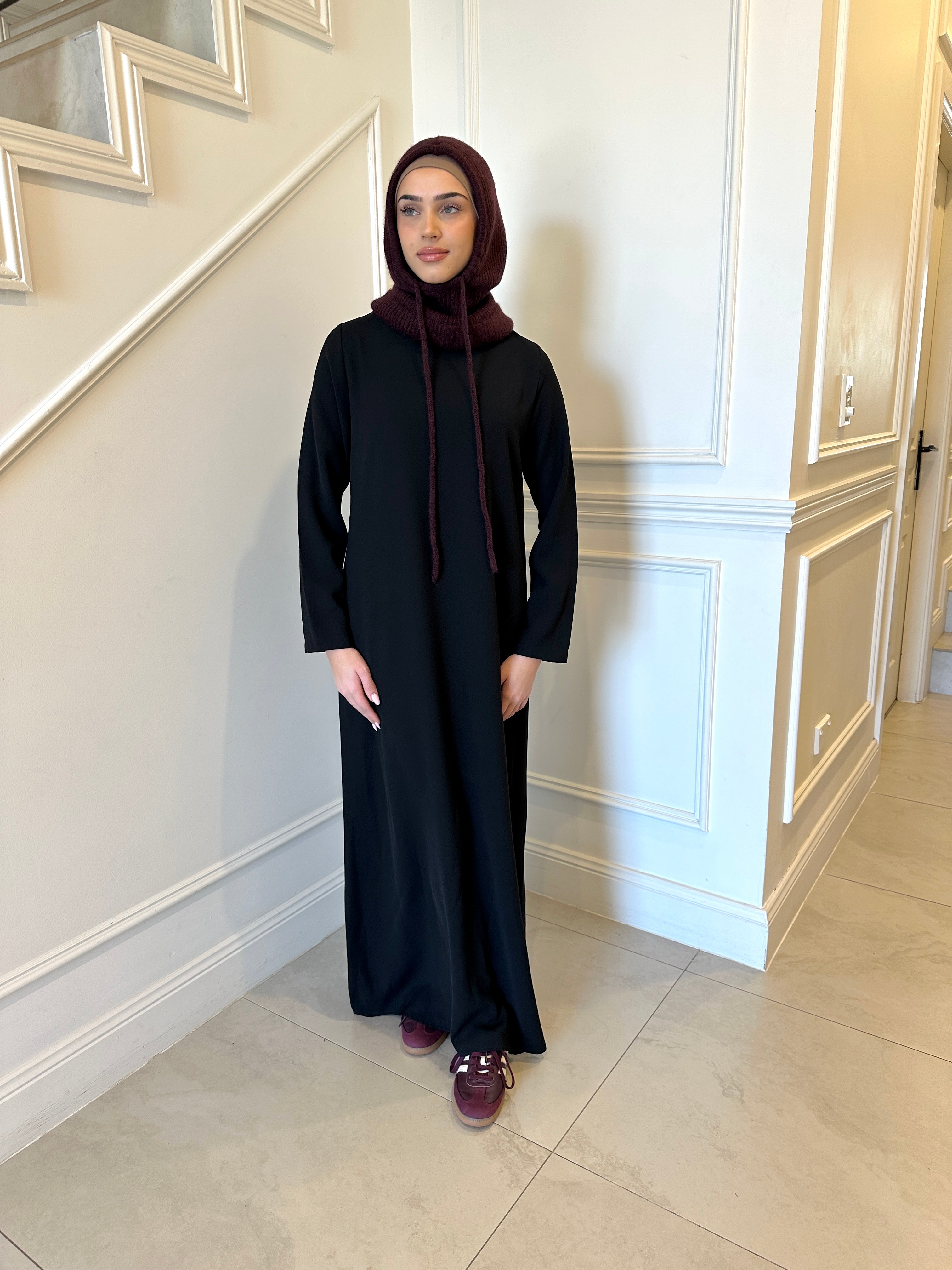 Basic Abaya in a classic straight-cut maxi silhouette with long sleeves and a round neckline. Minimalist design offers modest, polished elegance suitable for everyday wear or special occasions.