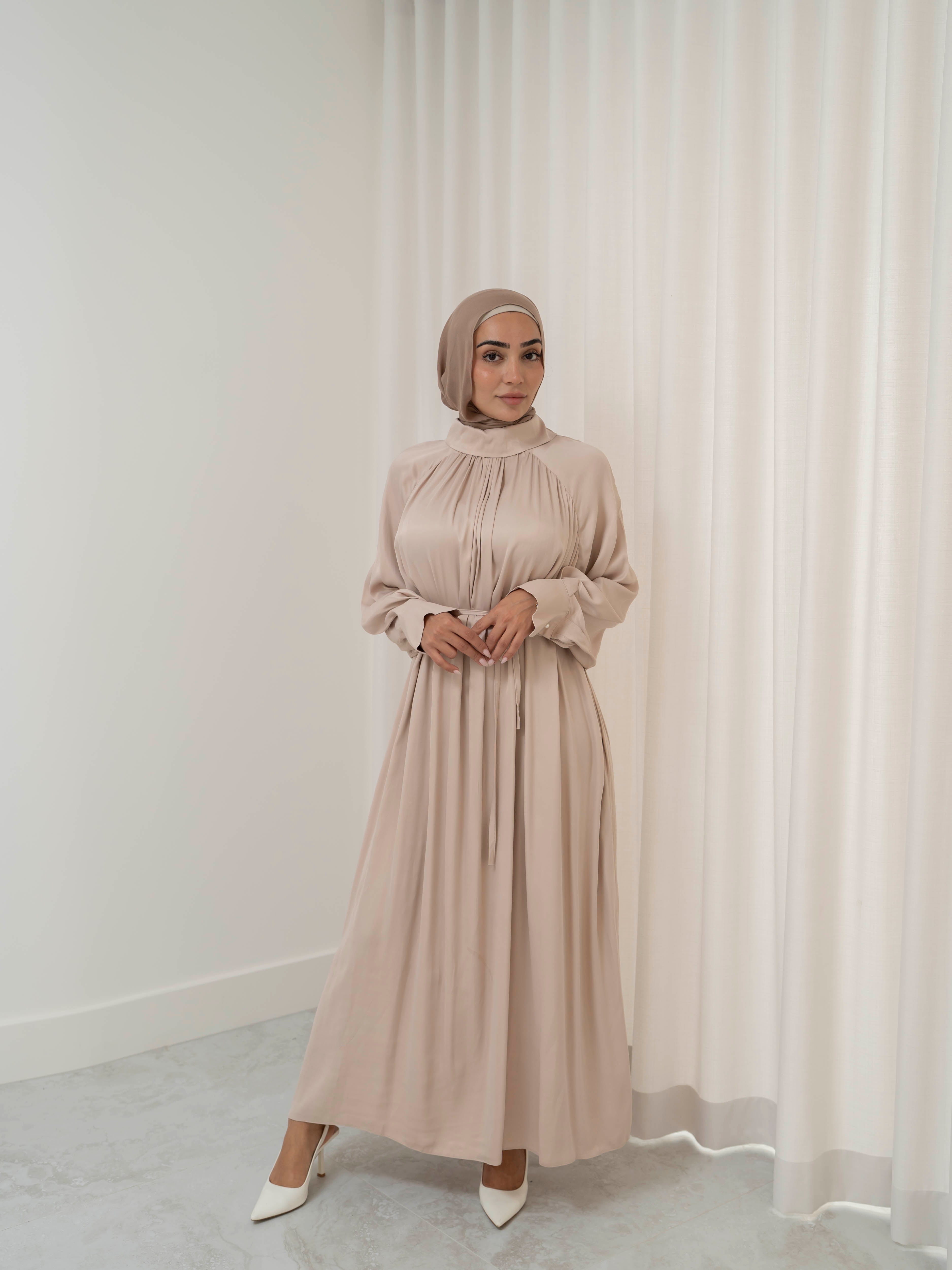 Celeste Tie Dress with a collared neckline, gathered bodice, and removable waist tie. Full-length with soft, fluid drape and subtle sheen, offering a graceful, elegant silhouette for Eid, special occasions, or evening wear.