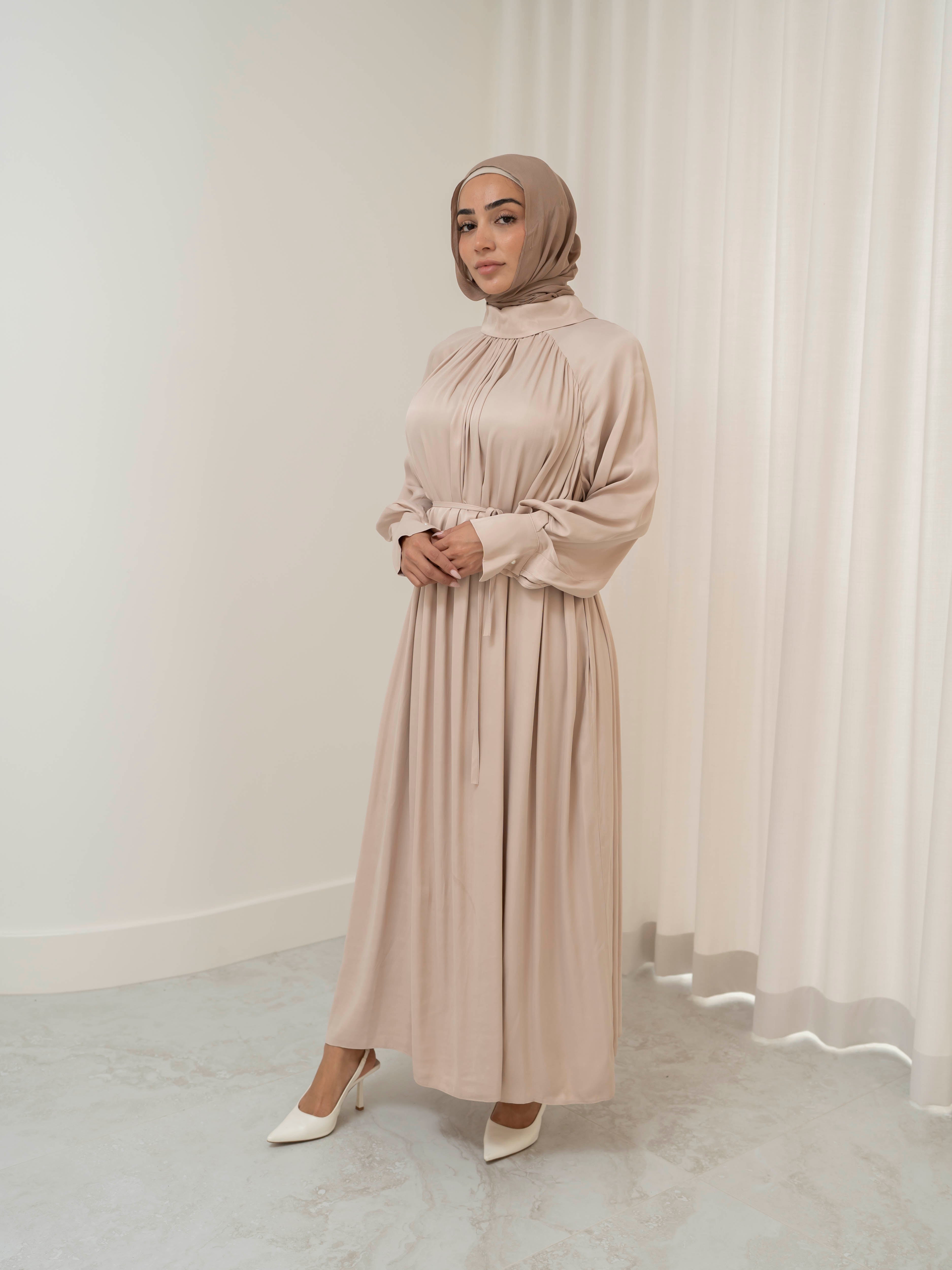 Celeste Tie Dress with a collared neckline, gathered bodice, and removable waist tie. Full-length with soft, fluid drape and subtle sheen, offering a graceful, elegant silhouette for Eid, special occasions, or evening wear.