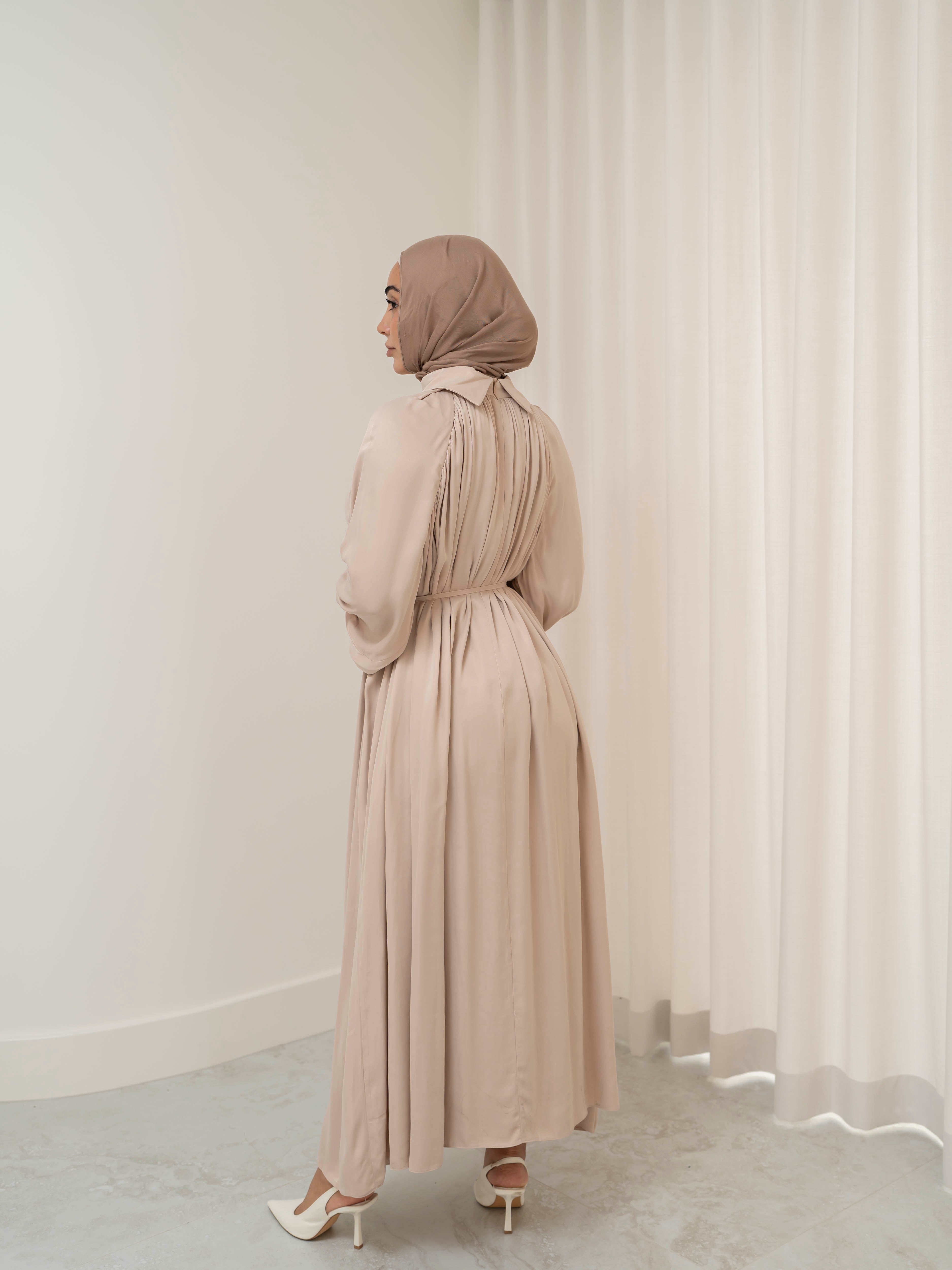 Celeste Tie Dress with a collared neckline, gathered bodice, and removable waist tie. Full-length with soft, fluid drape and subtle sheen, offering a graceful, elegant silhouette for Eid, special occasions, or evening wear.