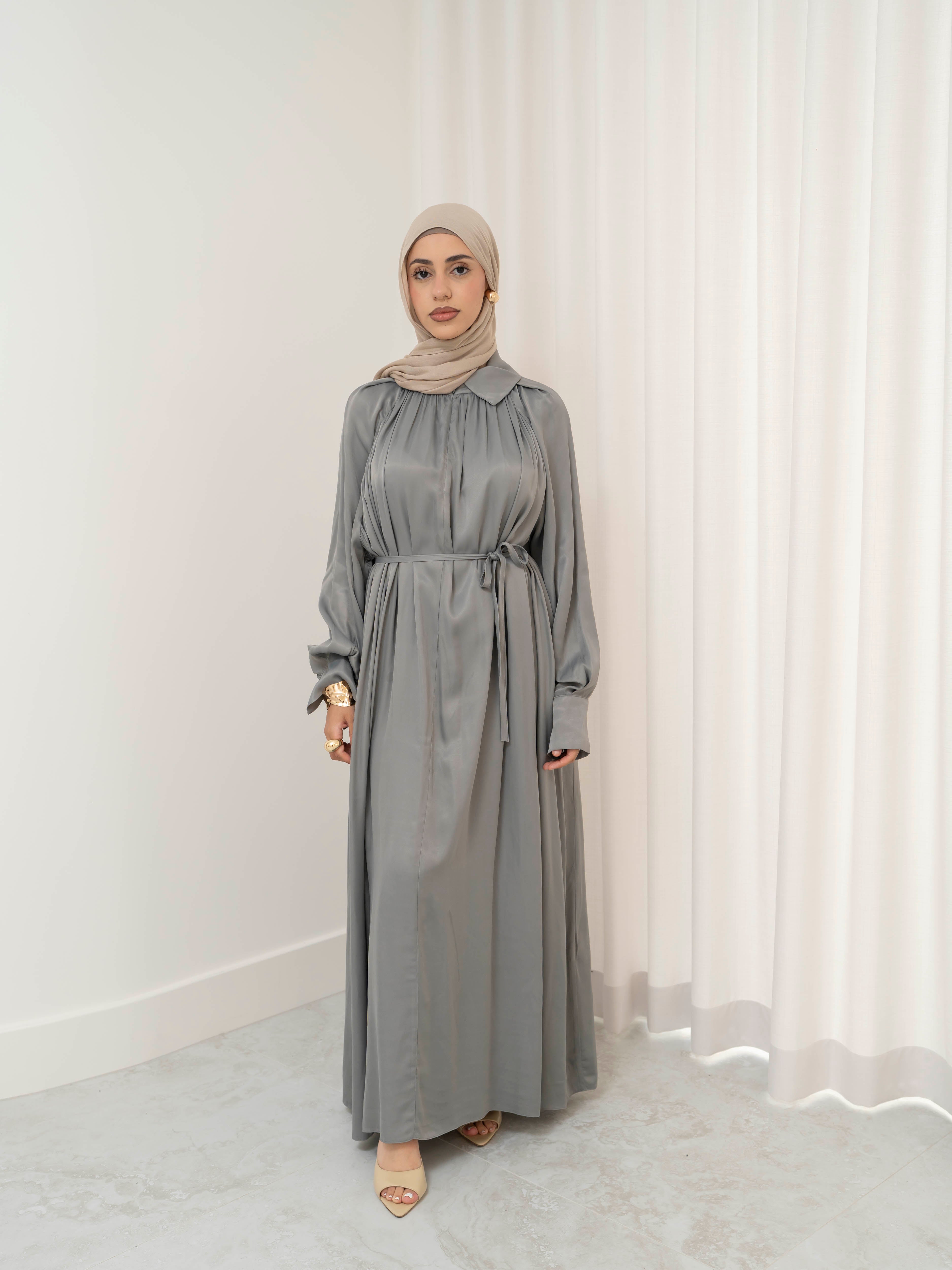 Celeste Tie Dress with a collared neckline, gathered bodice, and removable waist tie. Full-length with soft, fluid drape and subtle sheen, offering a graceful, elegant silhouette for Eid, special occasions, or evening wear.