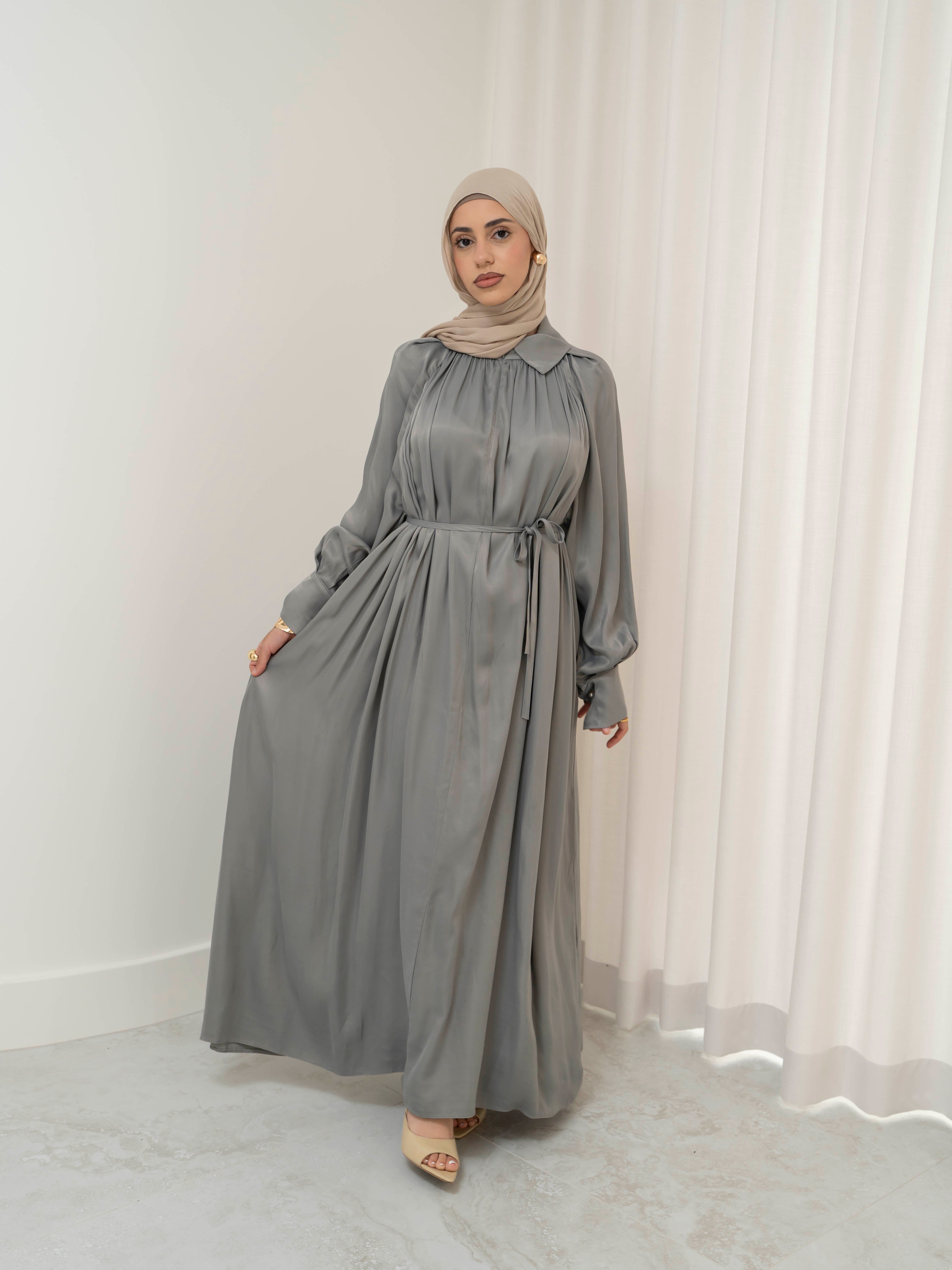 Celeste Tie Dress with a collared neckline, gathered bodice, and removable waist tie. Full-length with soft, fluid drape and subtle sheen, offering a graceful, elegant silhouette for Eid, special occasions, or evening wear.