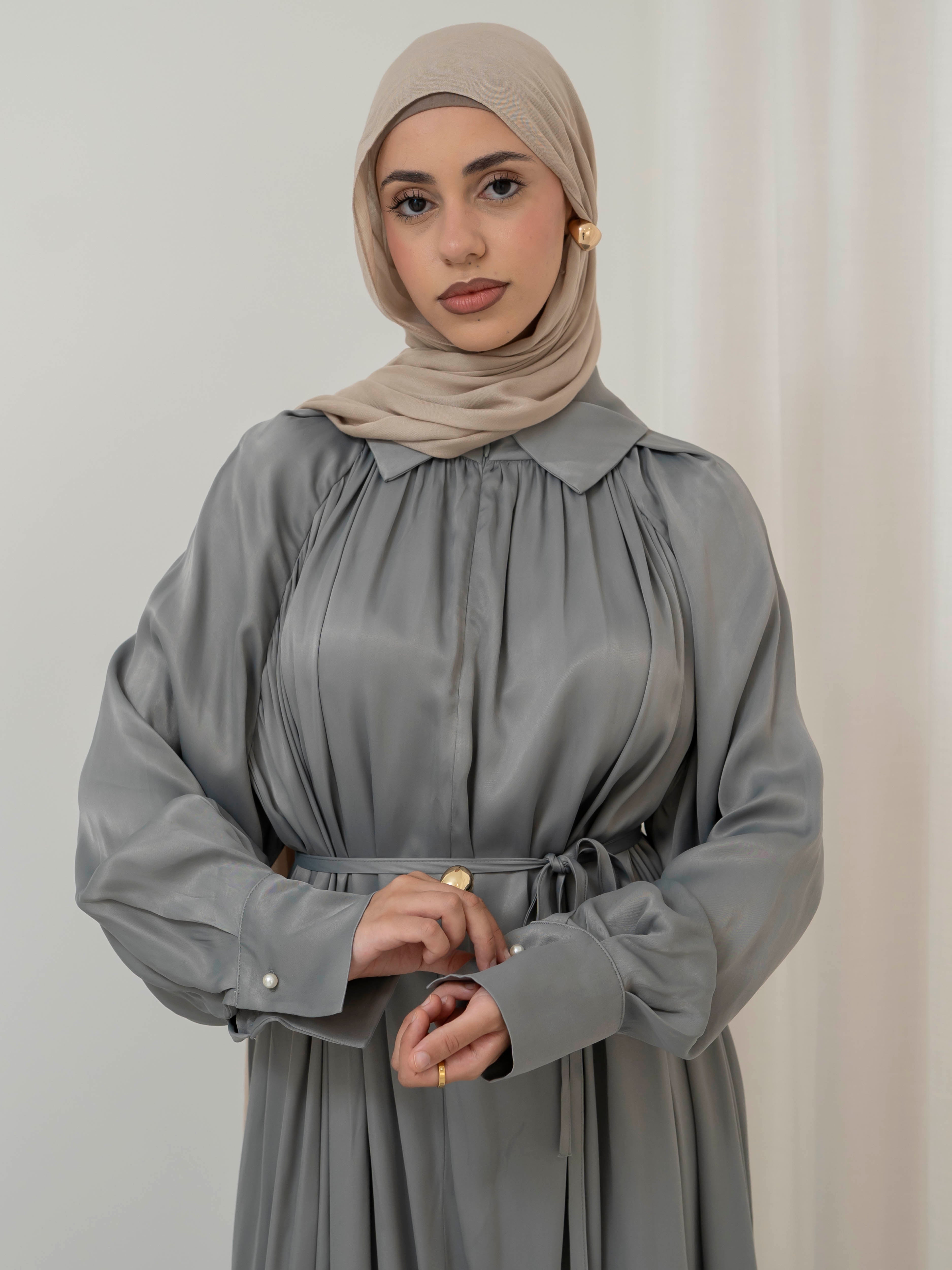 Celeste Tie Dress with a collared neckline, gathered bodice, and removable waist tie. Full-length with soft, fluid drape and subtle sheen, offering a graceful, elegant silhouette for Eid, special occasions, or evening wear.
