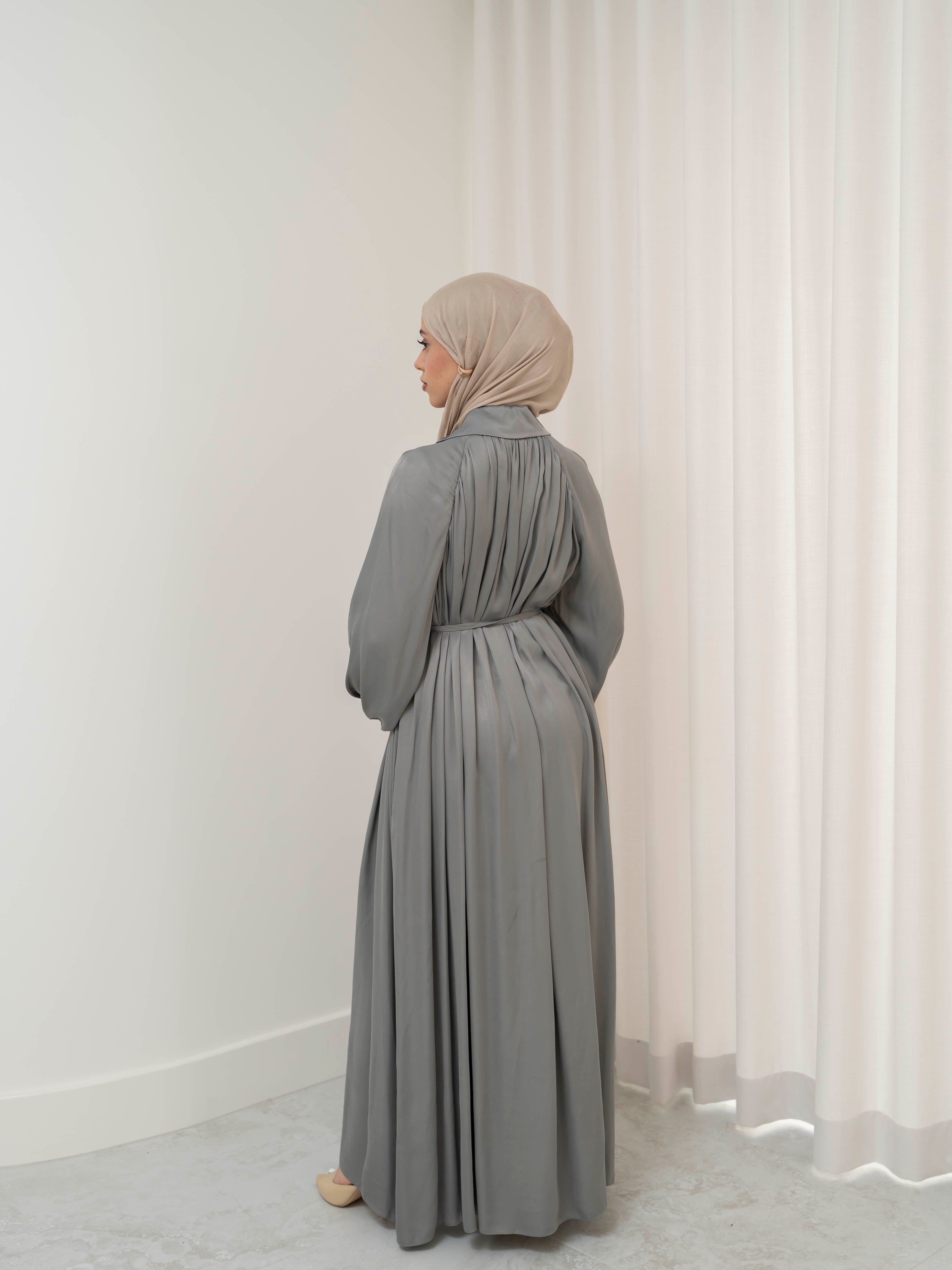 Celeste Tie Dress with a collared neckline, gathered bodice, and removable waist tie. Full-length with soft, fluid drape and subtle sheen, offering a graceful, elegant silhouette for Eid, special occasions, or evening wear.