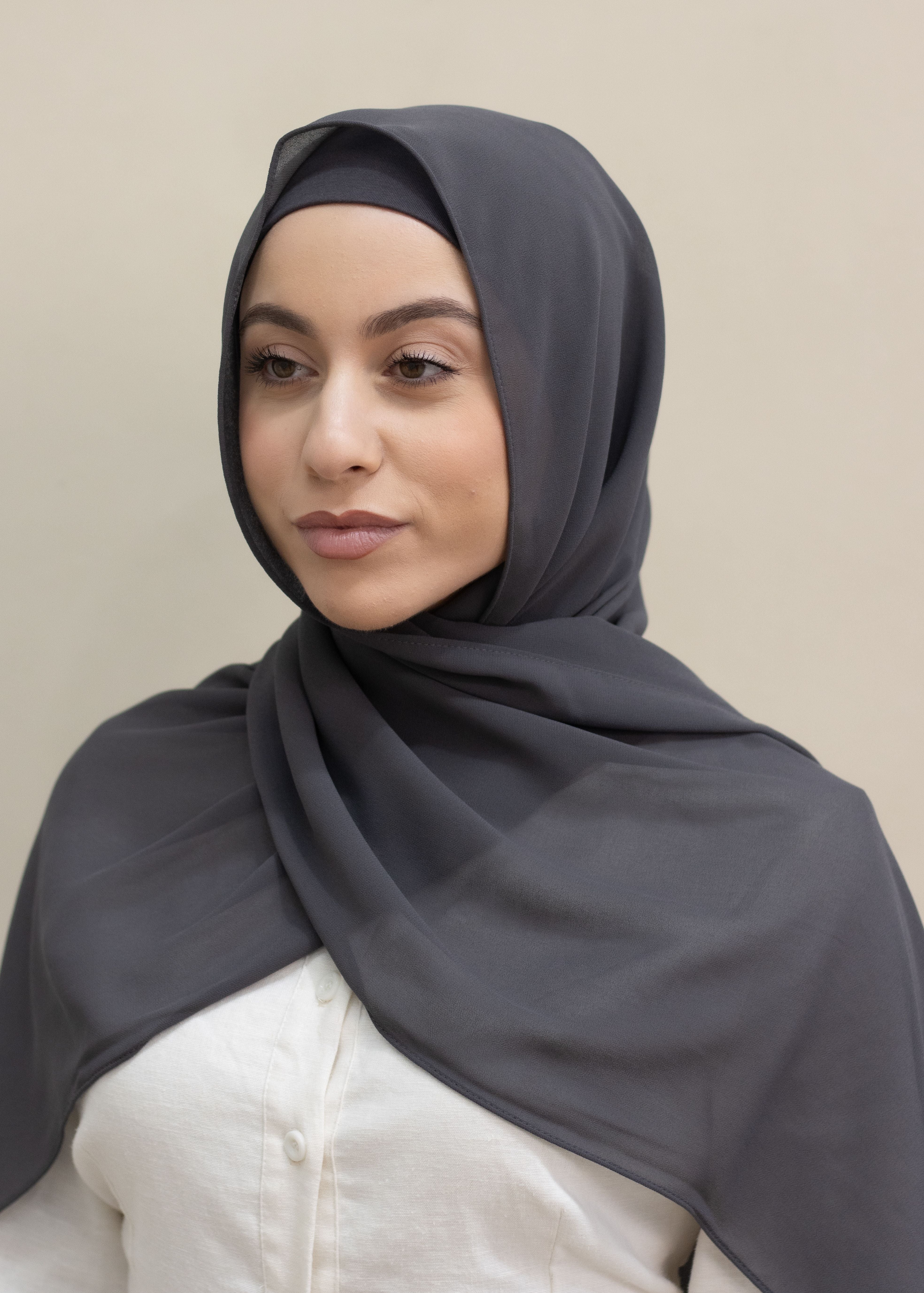 Signature crepe hijab with a soft, flowy drape and slightly higher opacity than chiffon. Features a non-slip finish for secure, comfortable all-day wear. Suitable for everyday use and special occasions. Includes matching open cotton undercap.