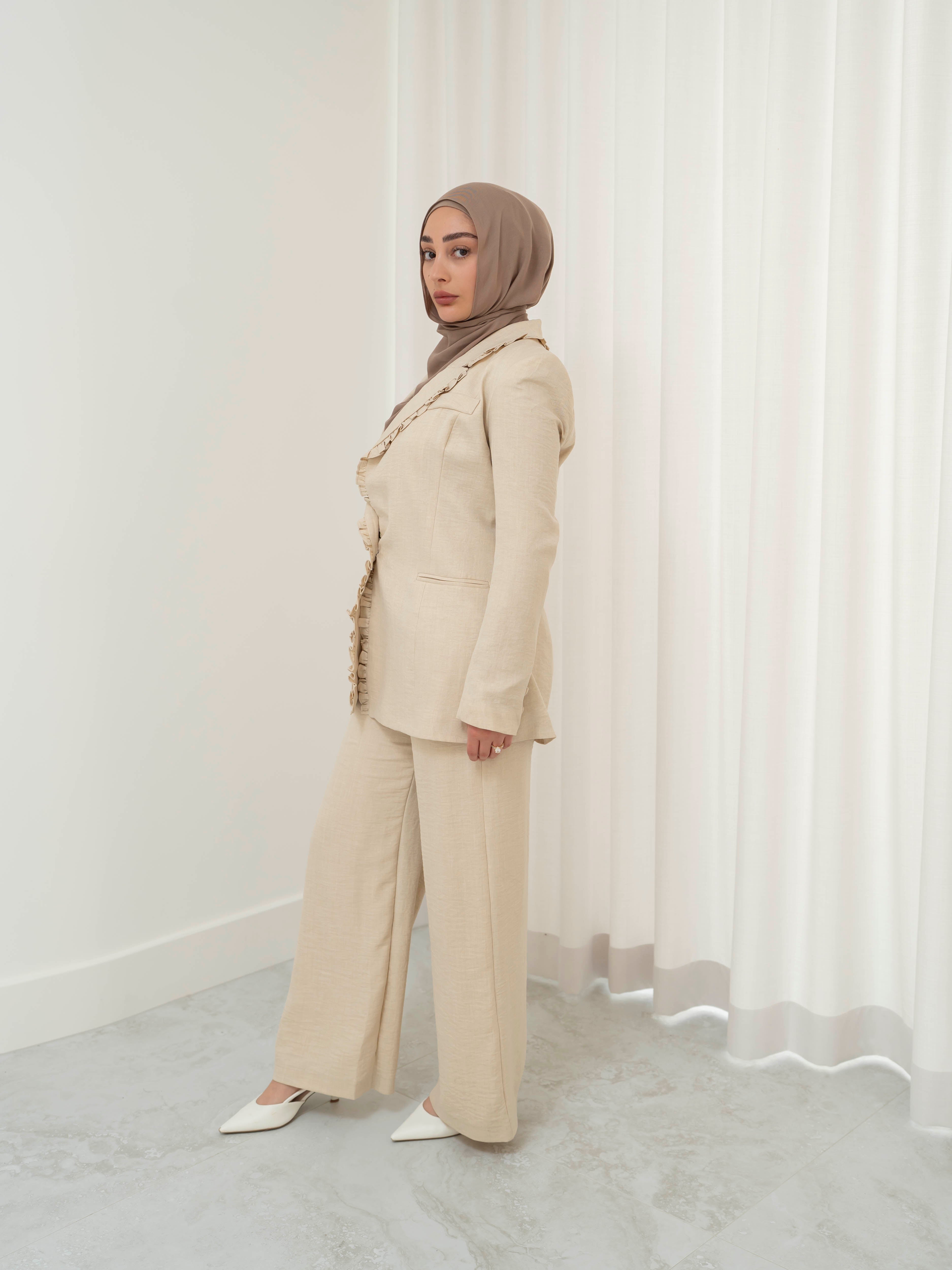 Tailored two-piece blazer and trouser suit set with a structured top and clean lines for a polished, elongated silhouette. Modest yet modern design ideal for formal events, office wear, and elevated everyday styling. Wear together for a statement look or style separately for versatile outfits.