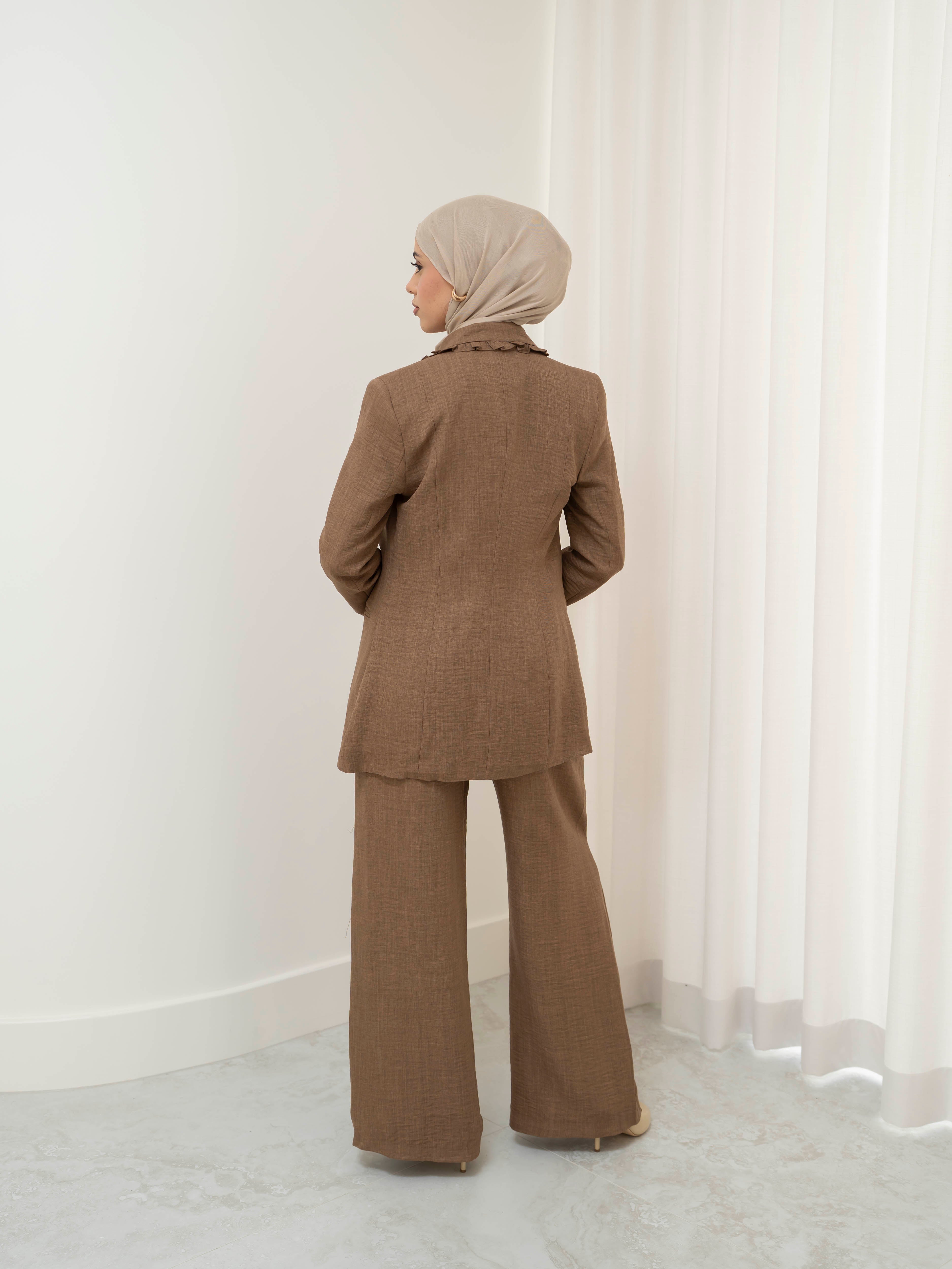 Tailored two-piece blazer and trouser suit set with a structured top and clean lines for a polished, elongated silhouette. Modest yet modern design ideal for formal events, office wear, and elevated everyday styling. Wear together for a statement look or style separately for versatile outfits.