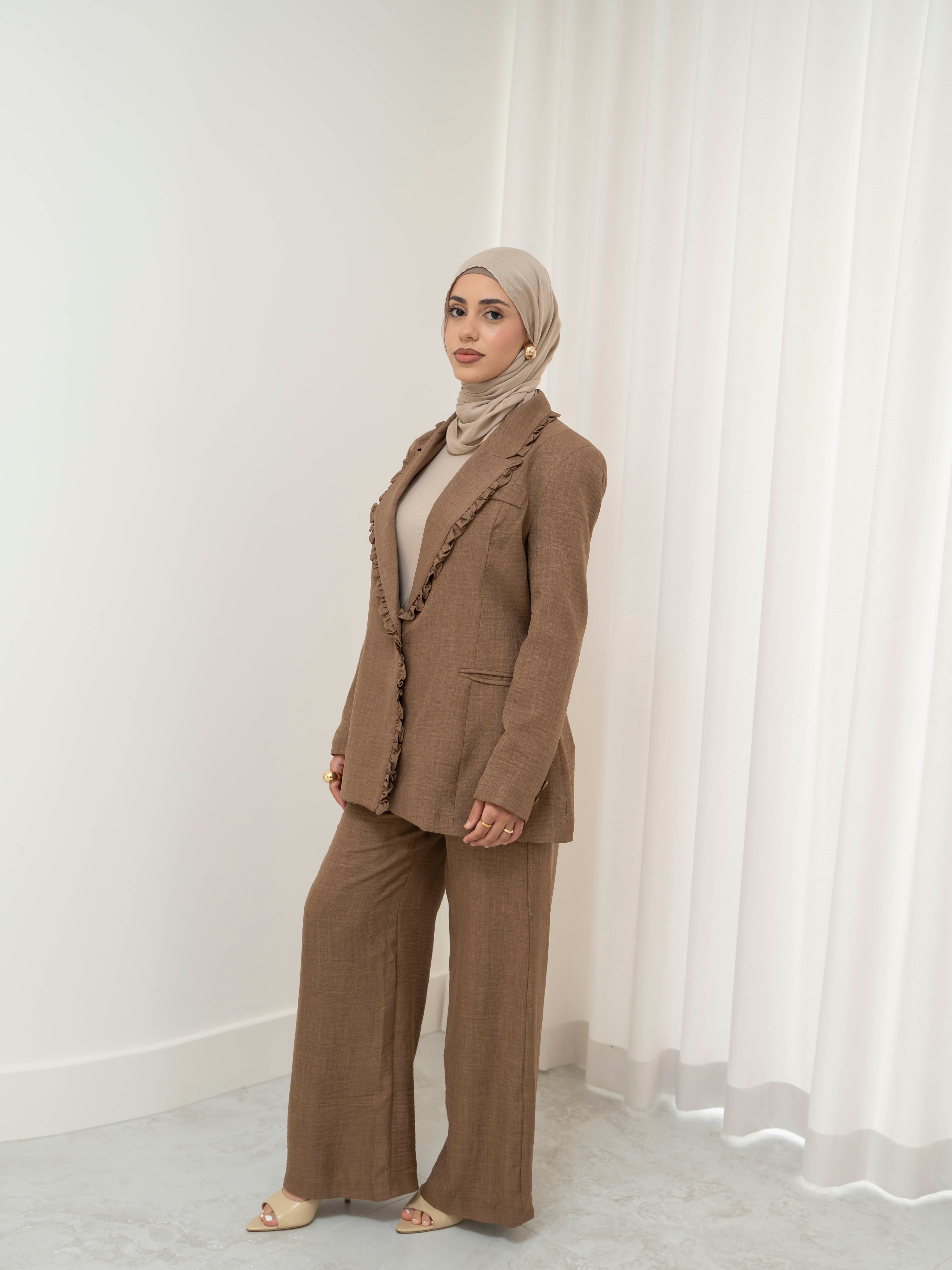 Tailored two-piece blazer and trouser suit set with a structured top and clean lines for a polished, elongated silhouette. Modest yet modern design ideal for formal events, office wear, and elevated everyday styling. Wear together for a statement look or style separately for versatile outfits.
