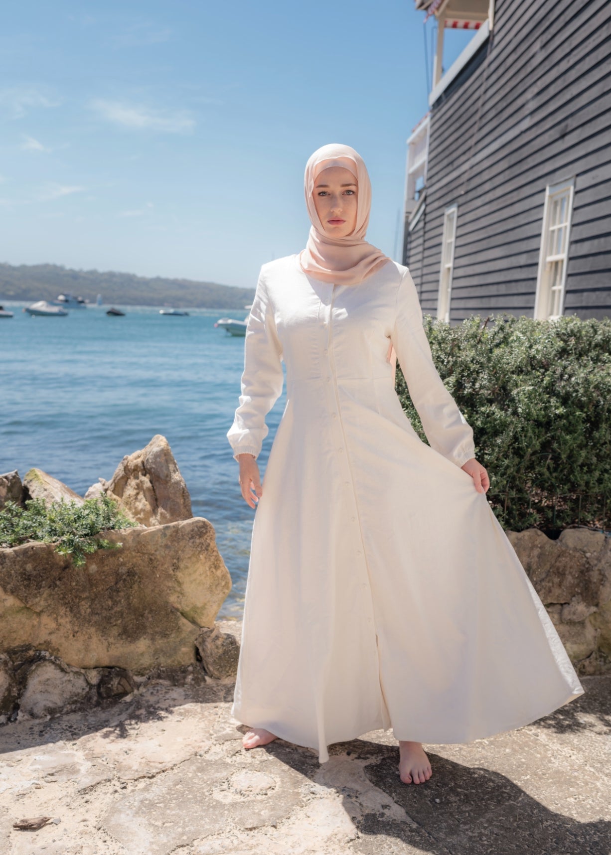 Ivory linen maxi dress with an A-line skirt and empire waist for a flattering silhouette. Features a round neckline and long balloon sleeves for an elegant touch. Lightweight and breathable, ideal for warm-weather wear and summer occasions.