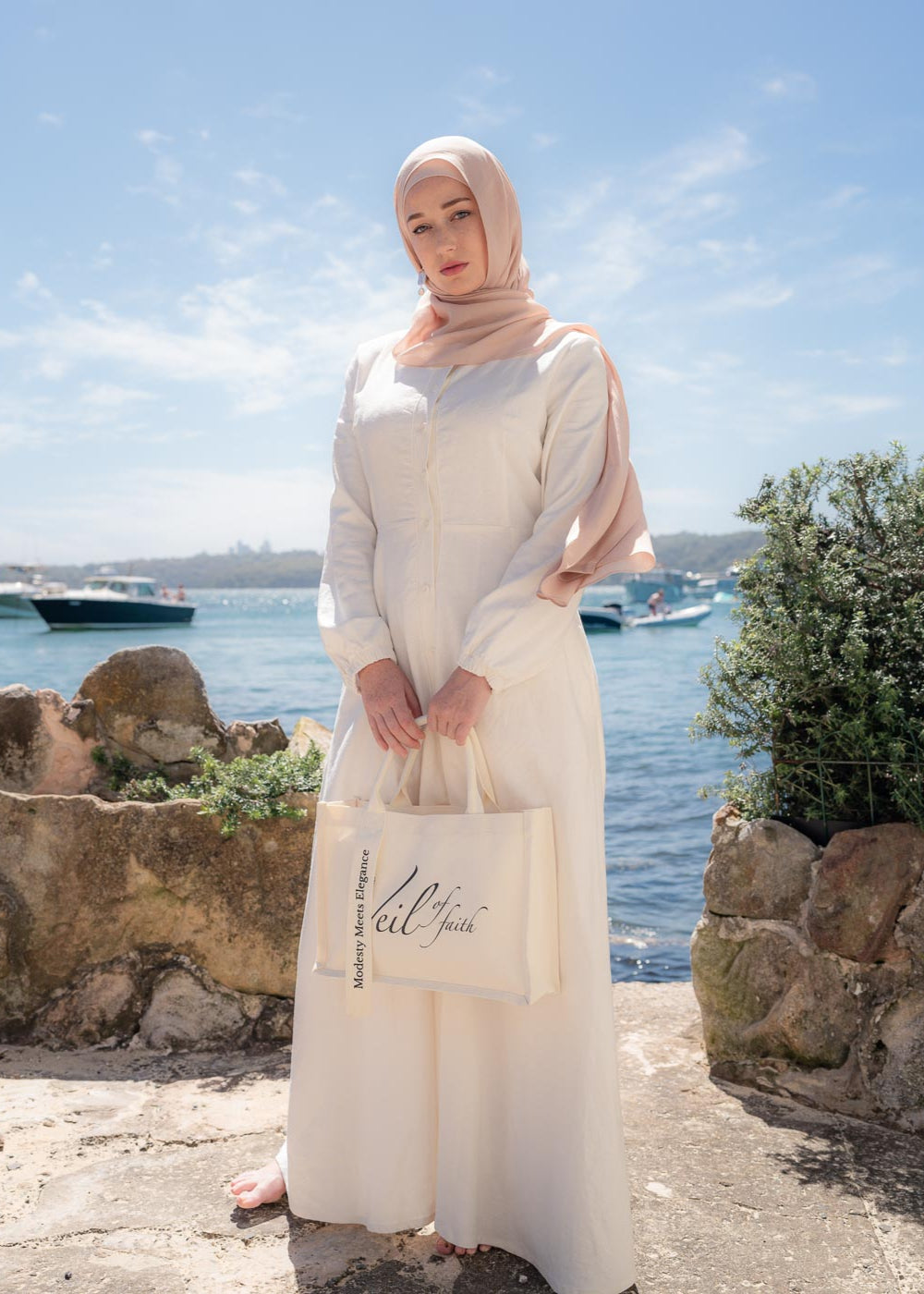 Ivory linen maxi dress with an A-line skirt and empire waist for a flattering silhouette. Features a round neckline and long balloon sleeves for an elegant touch. Lightweight and breathable, ideal for warm-weather wear and summer occasions.