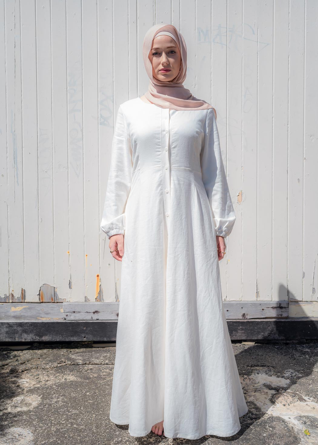 Ivory linen maxi dress with an A-line skirt and empire waist for a flattering silhouette. Features a round neckline and long balloon sleeves for an elegant touch. Lightweight and breathable, ideal for warm-weather wear and summer occasions.