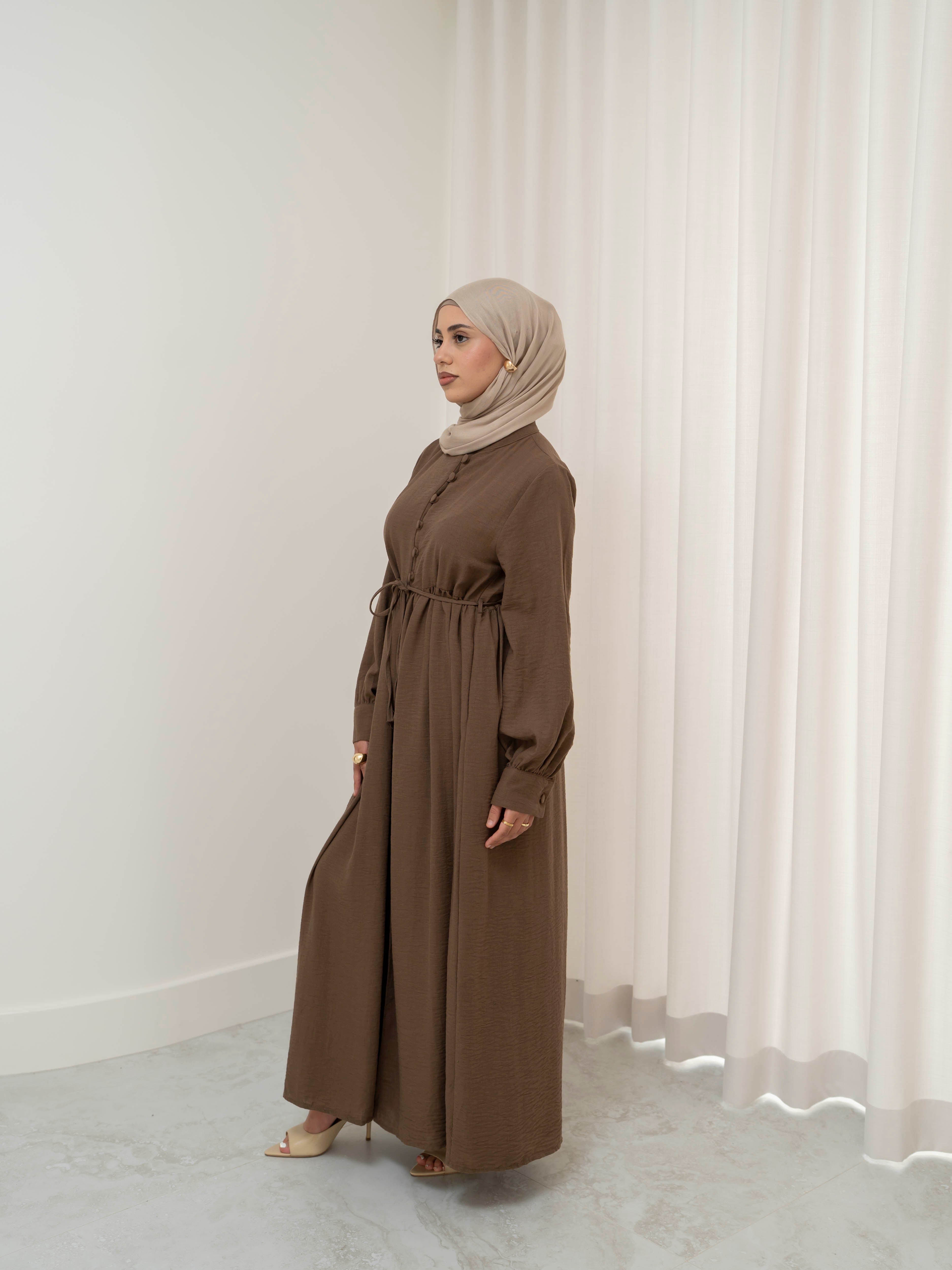 Luna Dress & Pant Set, a two-piece outfit featuring a flowing button-front dress with adjustable waist tie and matching high-waisted pants with elastic waistband and side pockets. Long sleeves with cuffs, lightweight fabric with elegant drape, designed for modest, polished looks suitable for Eid, special occasions, or everyday wear.