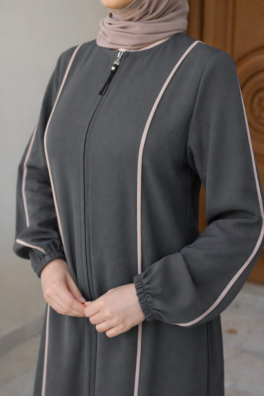 Elara Abaya with a longline, modest silhouette featuring a centre-front concealed zipper and elegant contrast piping. Flowing, structured design offers polished, tailored drape, ideal for everyday wear, gatherings, or Ramadan.