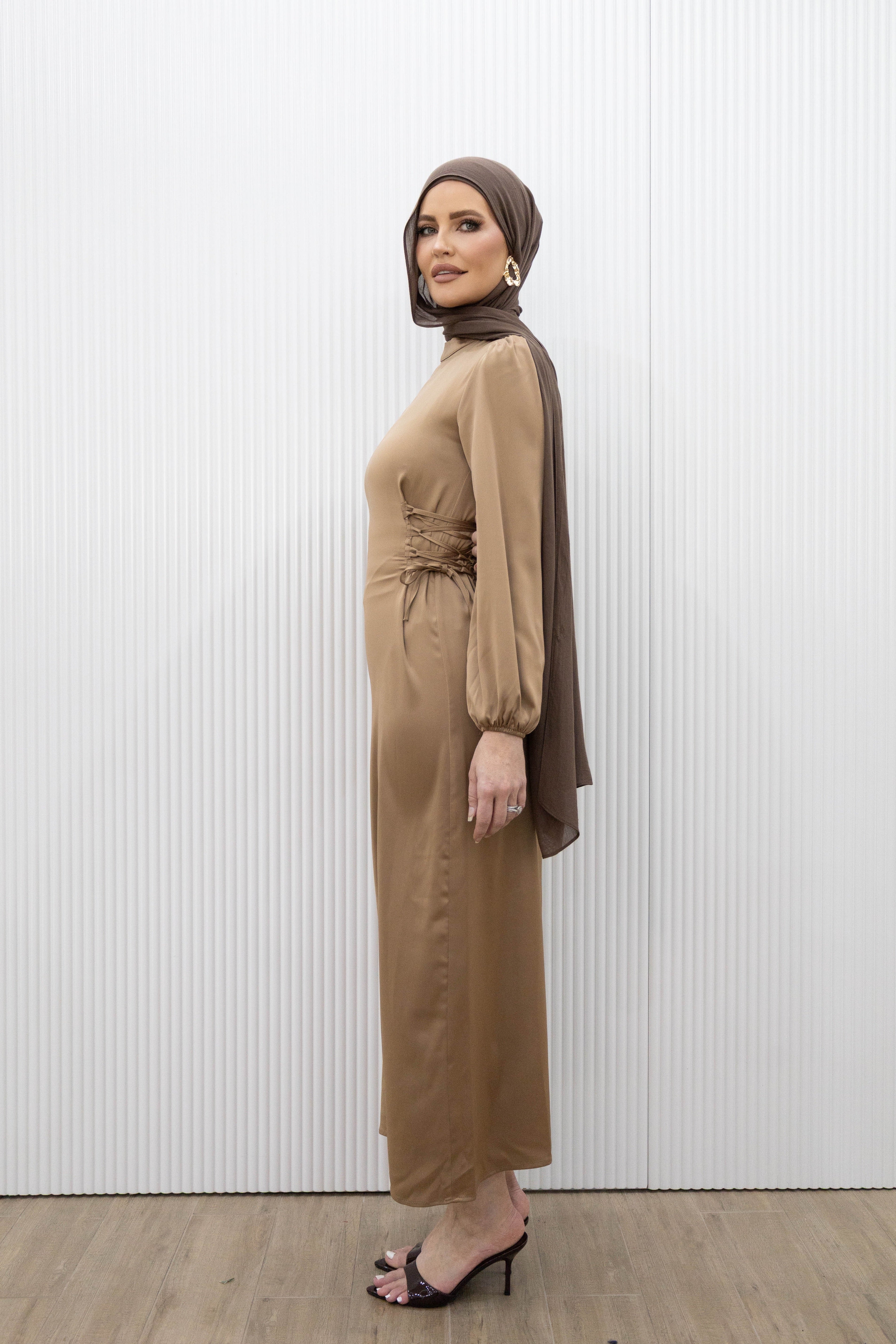 Channel an effortlessly simple elegance with our HANA SATIN DRESS. This midi dress boasts a fitted bodice and long blouson sleeves for a flattering silhouette. The lace ties at the back cinch in the waist, while the ankle length hem highlights a statement heel. Whether it's a dinner date or a girls night out, this dress is the perfect choice.