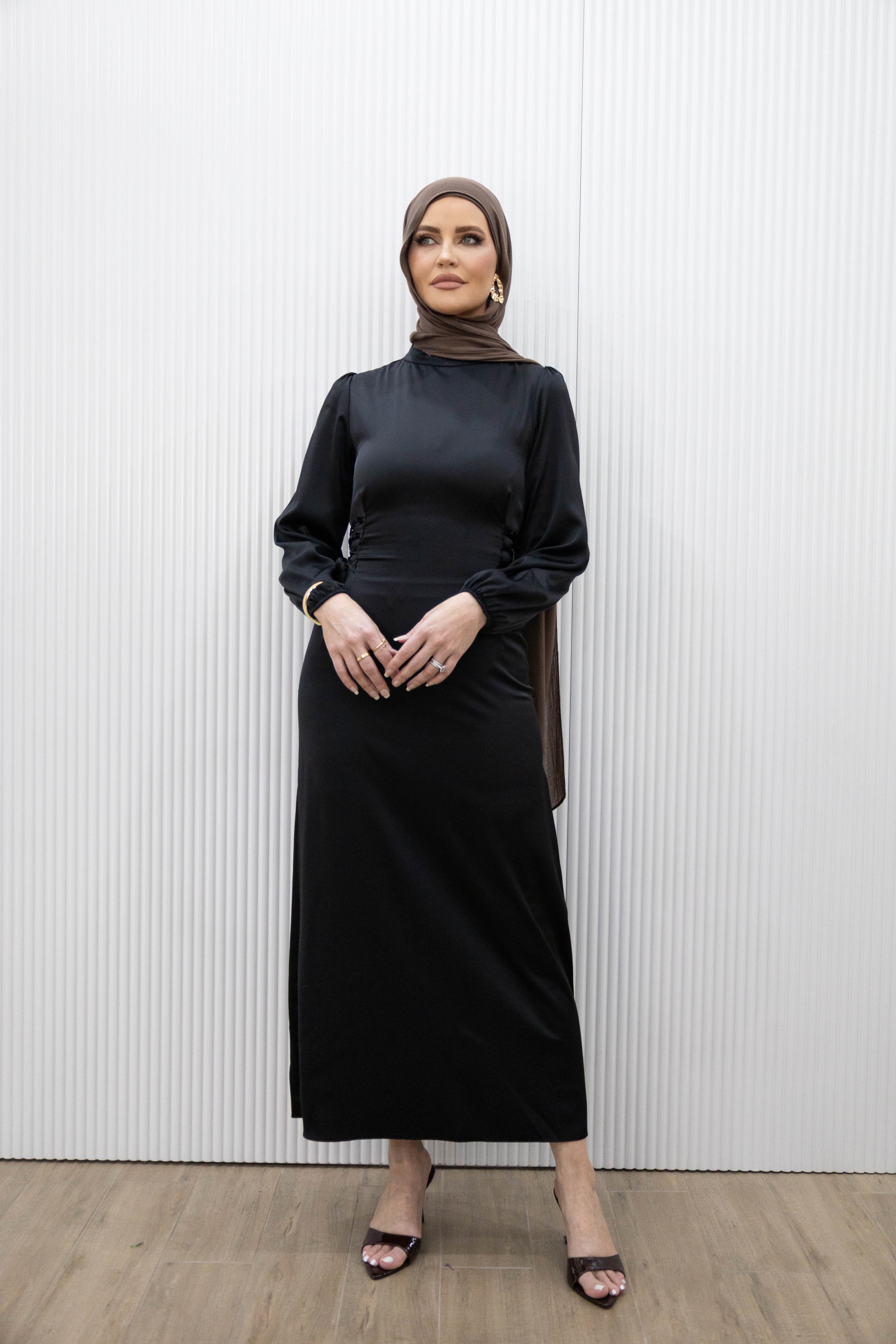 Channel an effortlessly simple elegance with our HANA SATIN DRESS. This midi dress boasts a fitted bodice and long blouson sleeves for a flattering silhouette. The lace ties at the back cinch in the waist, while the ankle length hem highlights a statement heel. Whether it's a dinner date or a girls night out, this dress is the perfect choice.