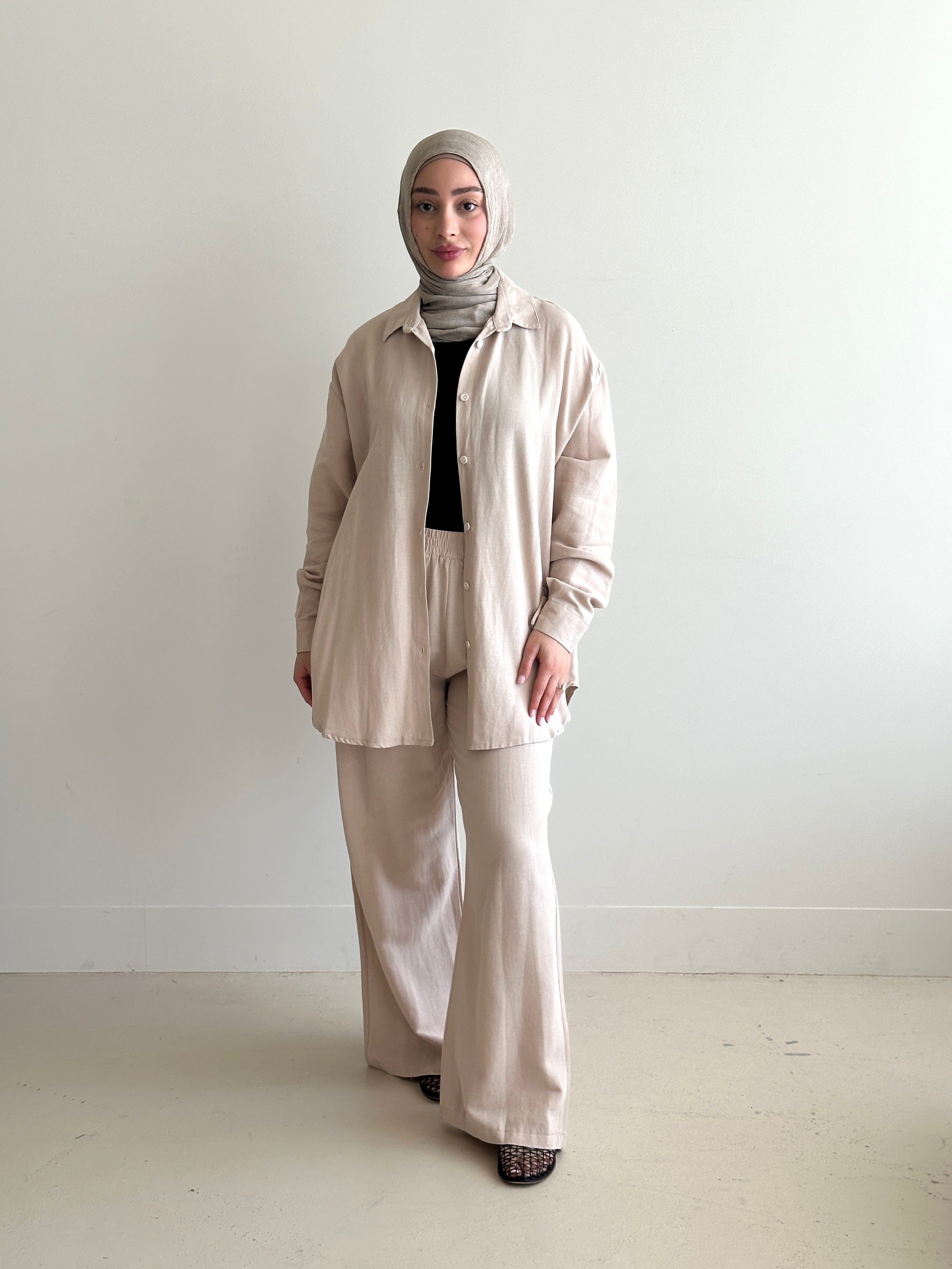 Designed for versatile styling, this set pairs a modest top with a matching pant.