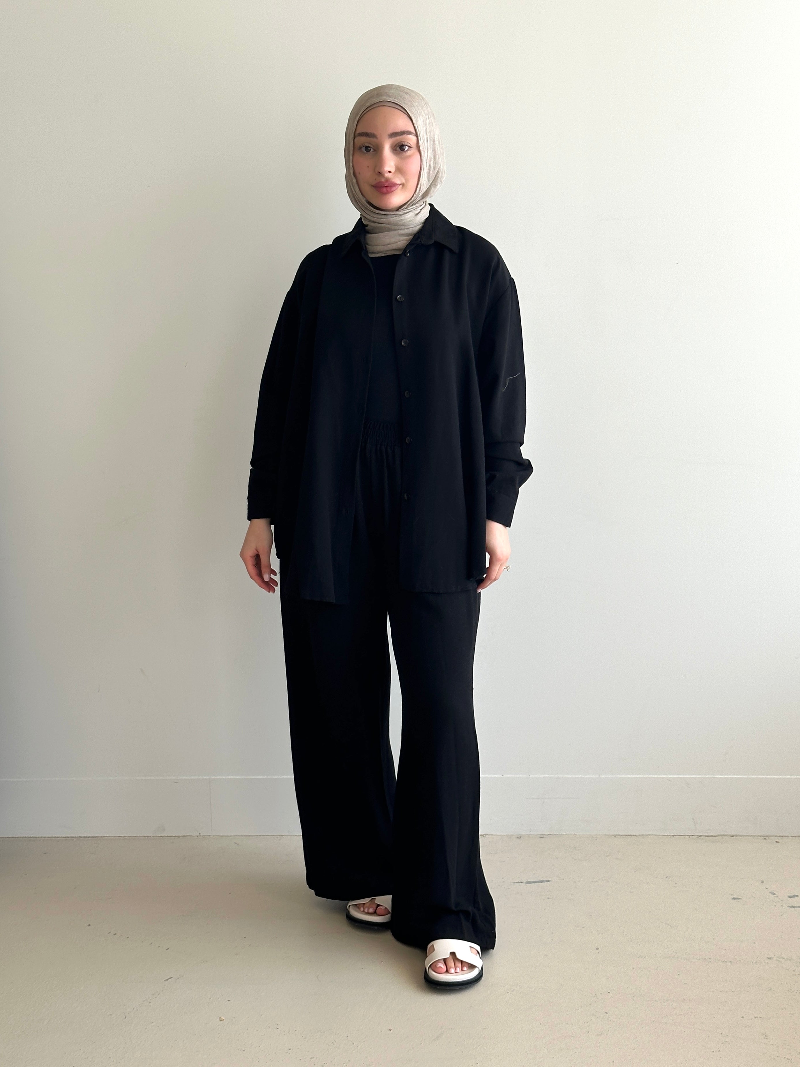 Designed for versatile styling, this set pairs a modest top with a matching pant.