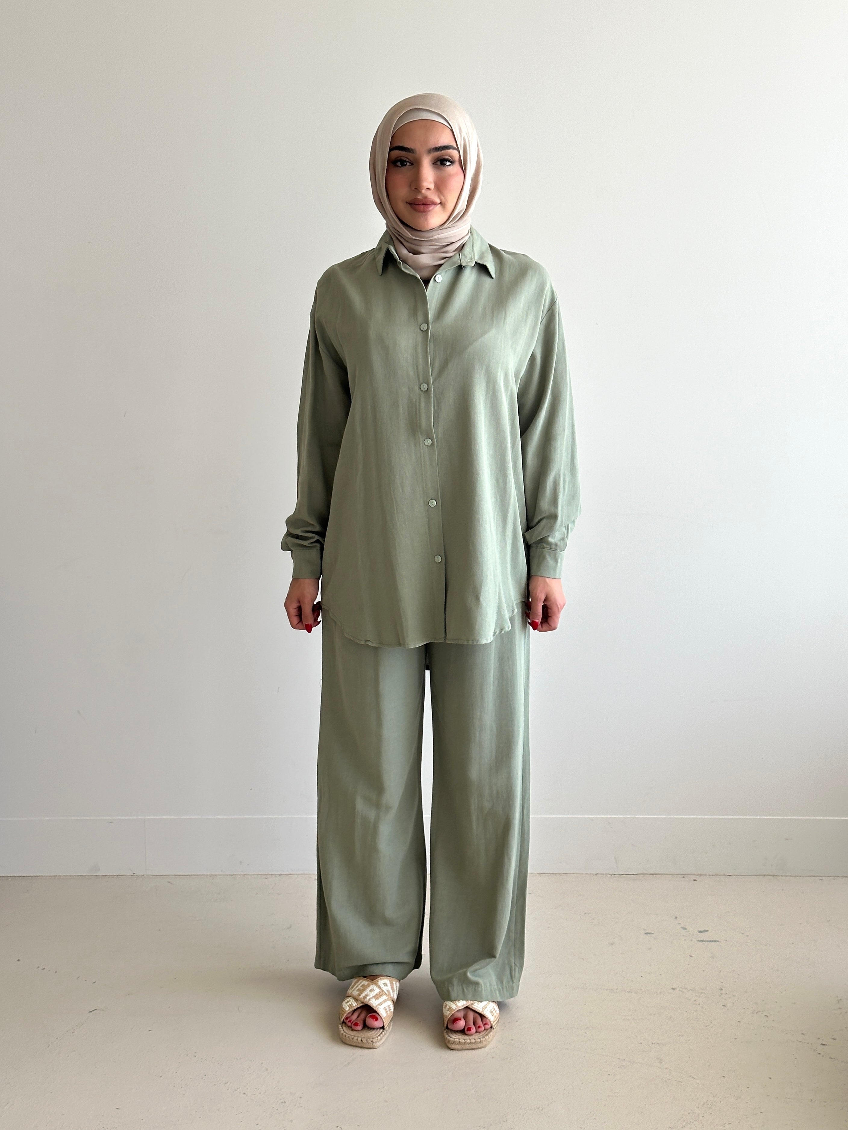 Designed for versatile styling, this set pairs a modest top with a matching pant.