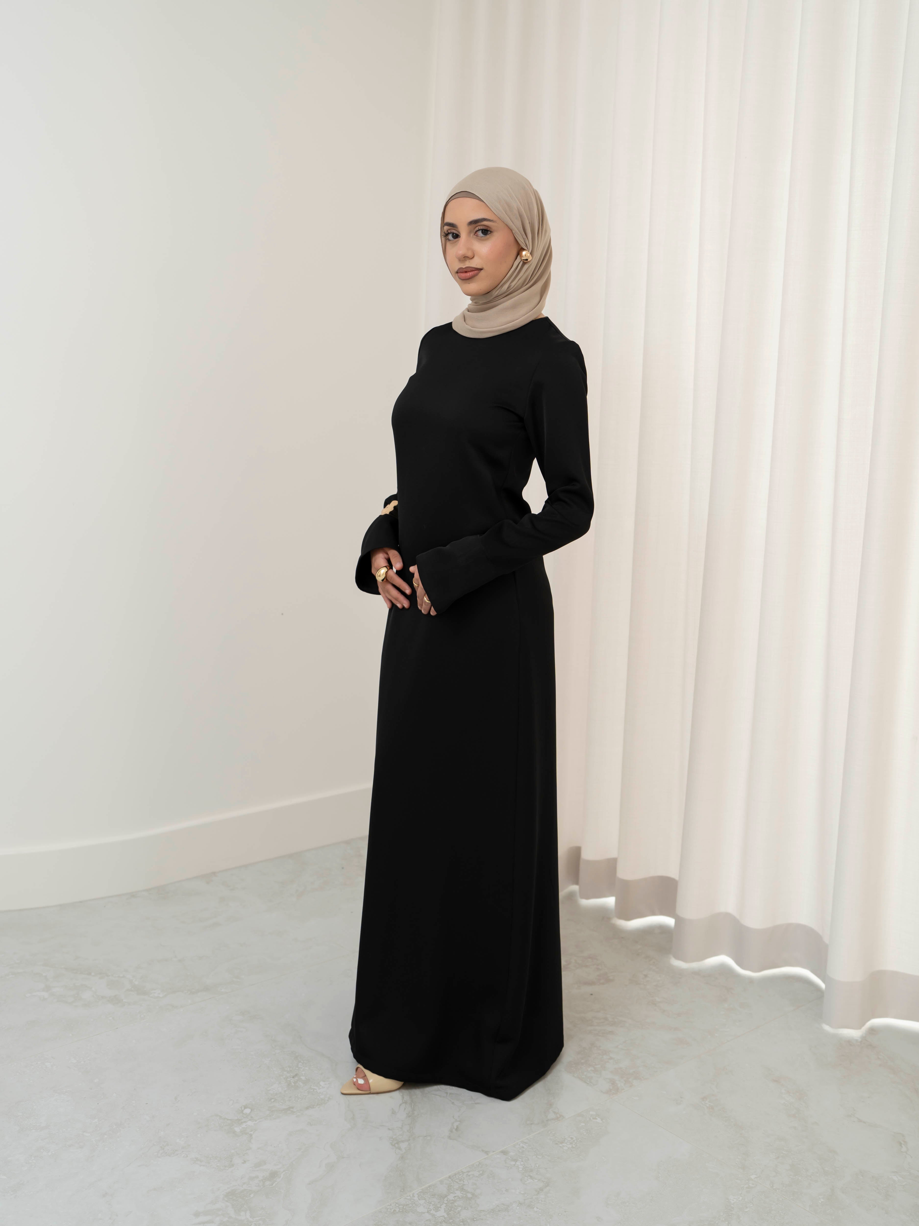 Lumière Satin Dress in smooth, fully lined satin with a soft sheen, featuring a modest, timeless cut and fluid drape that creates an elegant silhouette. Ideal for formal events, evening occasions, and special celebrations.