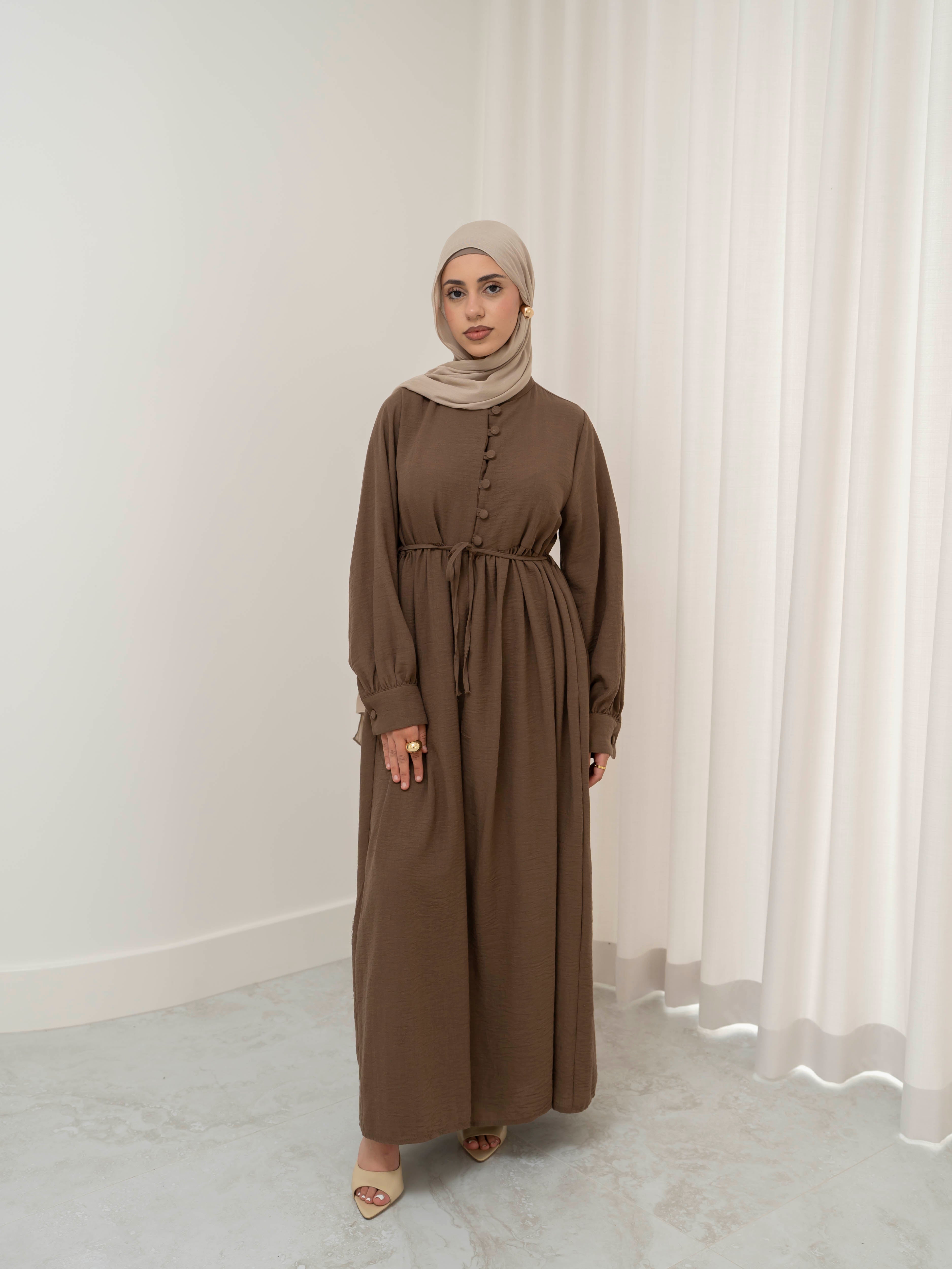 Luna Dress & Pant Set, a two-piece outfit featuring a flowing button-front dress with adjustable waist tie and matching high-waisted pants with elastic waistband and side pockets. Long sleeves with cuffs, lightweight fabric with elegant drape, designed for modest, polished looks suitable for Eid, special occasions, or everyday wear.