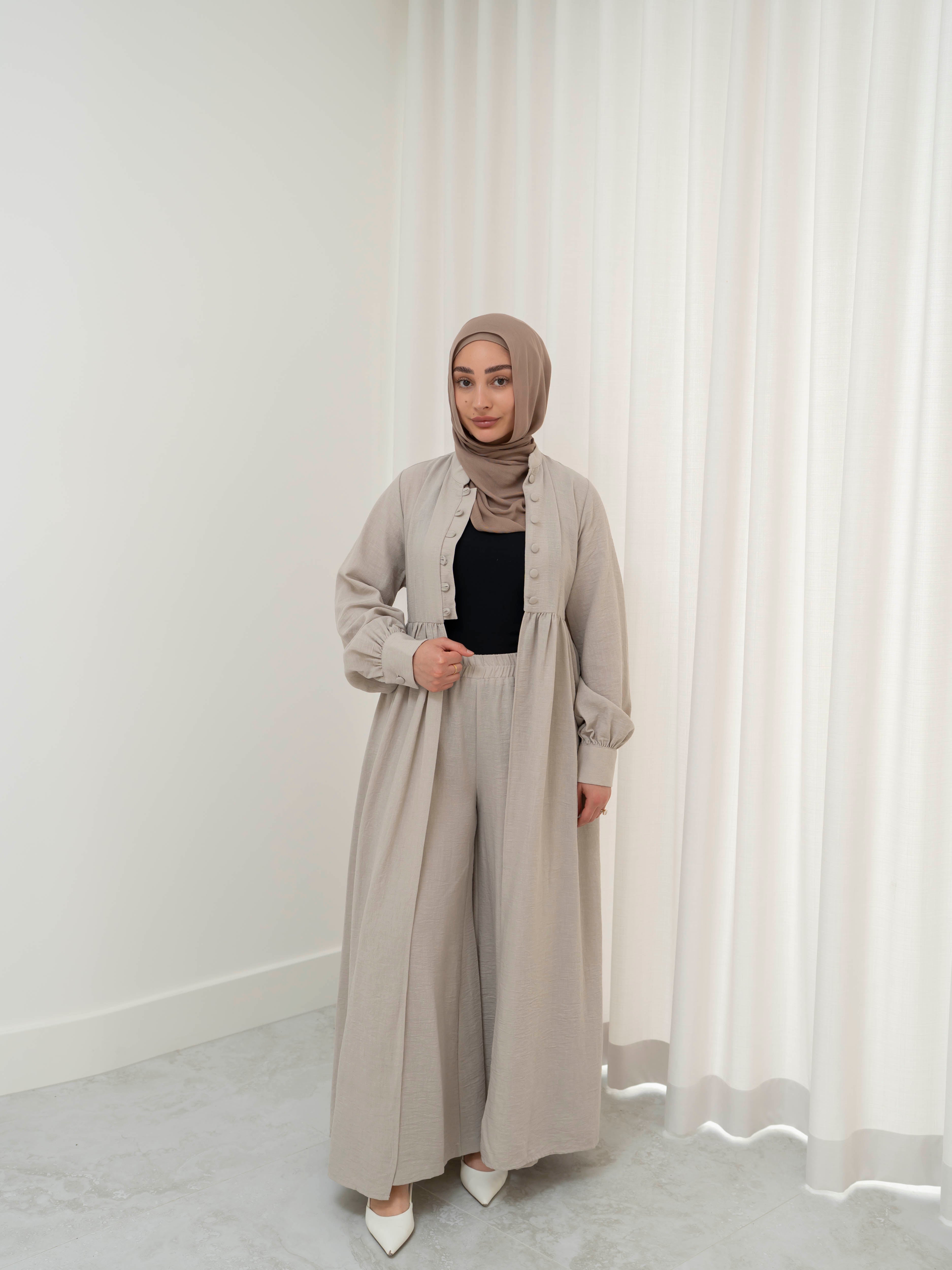 Luna Dress & Pant Set, a two-piece outfit featuring a flowing button-front dress with adjustable waist tie and matching high-waisted pants with elastic waistband and side pockets. Long sleeves with cuffs, lightweight fabric with elegant drape, designed for modest, polished looks suitable for Eid, special occasions, or everyday wear.