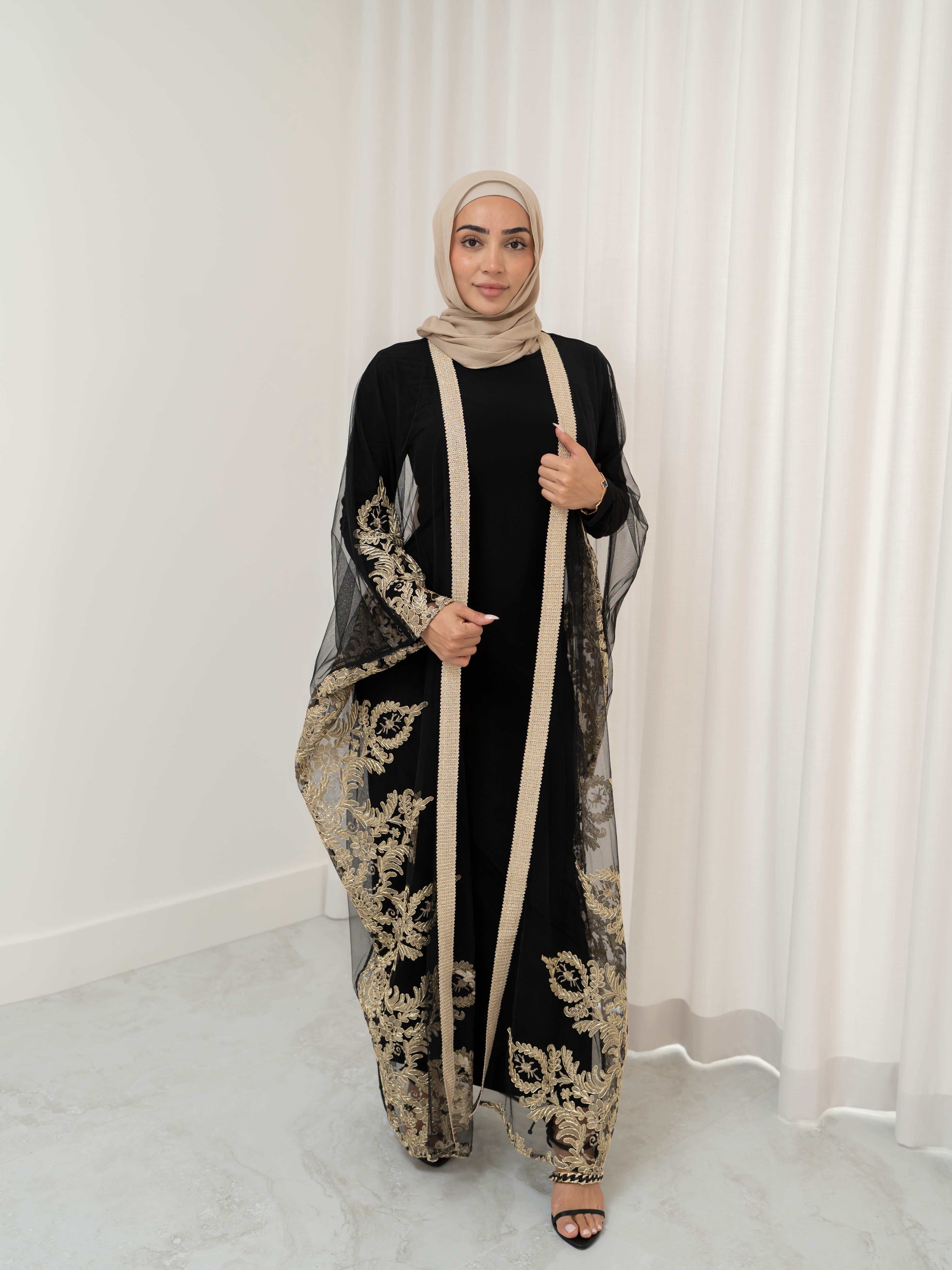 Elegant black lace abaya set with intricate gold embroidery woven throughout, creating a subtle regal shimmer. The outer layer features delicate lace detailing with refined gold accents that balance luxury and modesty. Paired with a coordinating long-sleeve black inner dress, the set offers full coverage and a smooth, flattering layered silhouette, designed for formal occasions and special events.