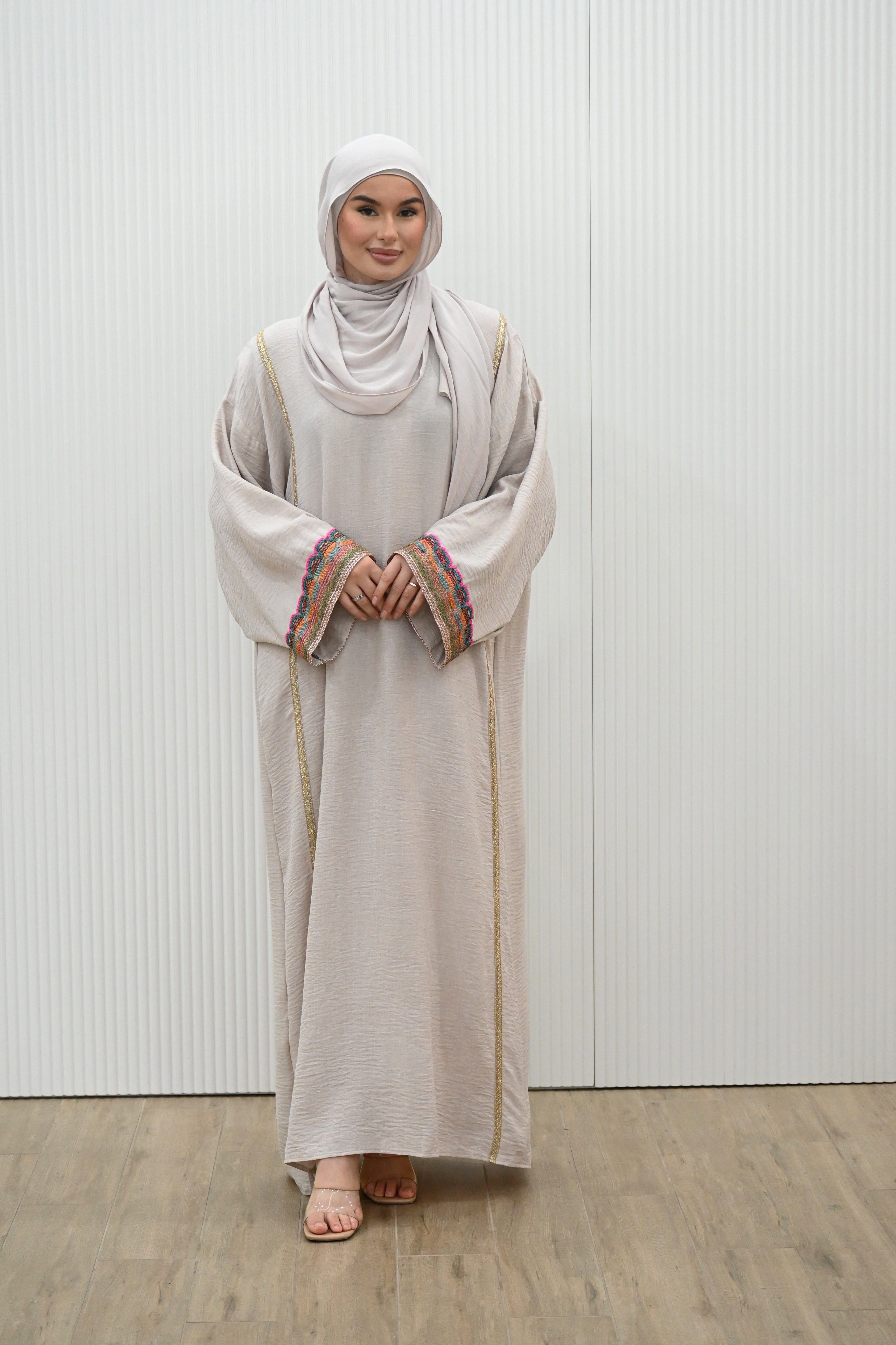 The MANEL&nbsp; DRESS - the perfect addition to your wardrobe. With its&nbsp; style silhouette adding a modest elegance, this dress is ideal for any evening occasions or a look for an invites. The long kimono sleeves feature intricate embroidery in a vibrant multi-coloured print, adding a touch of sparkle to your mood.