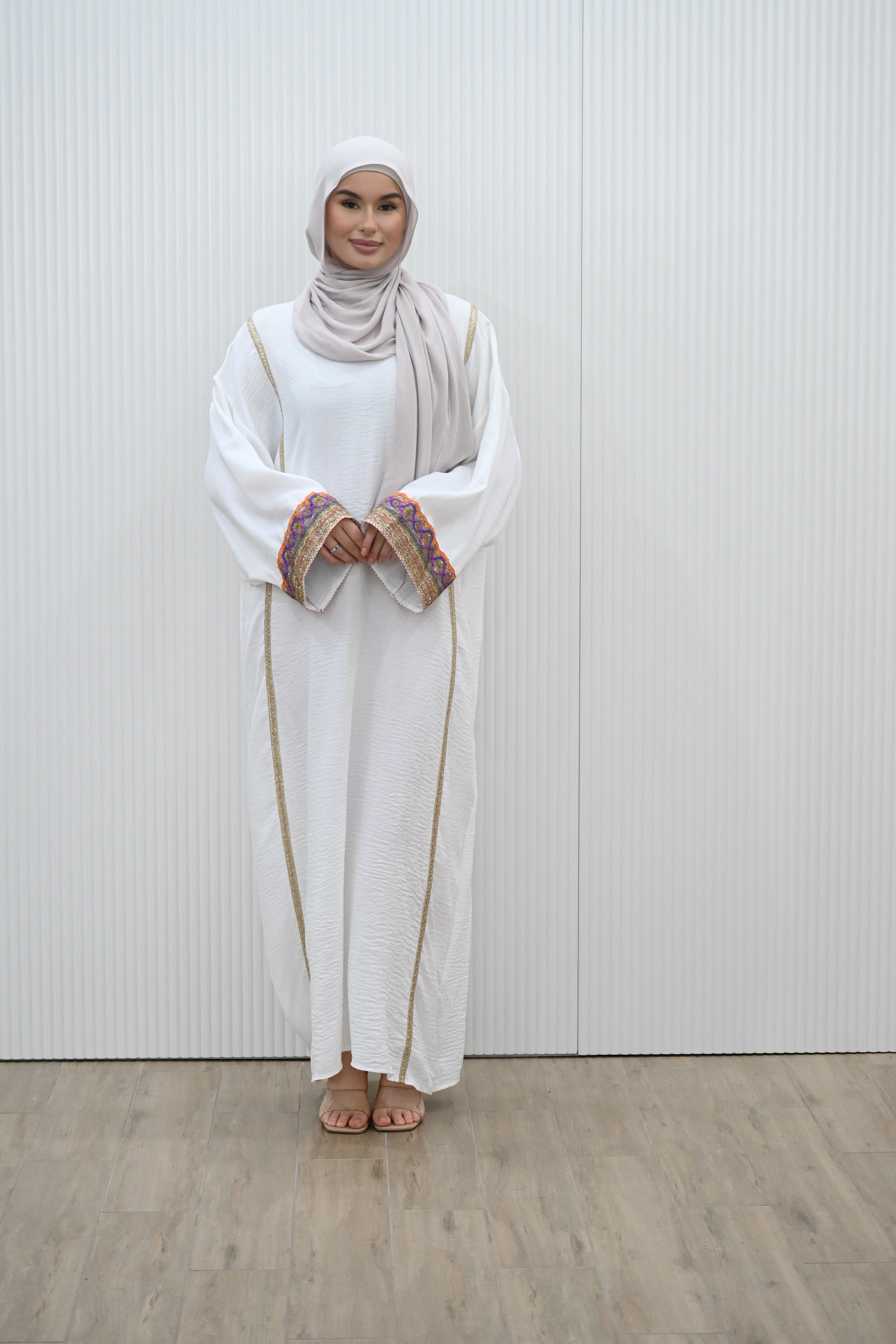 The MANEL&nbsp; DRESS - the perfect addition to your wardrobe. With its&nbsp; style silhouette adding a modest elegance, this dress is ideal for any evening occasions or a look for an invites. The long kimono sleeves feature intricate embroidery in a vibrant multi-coloured print, adding a touch of sparkle to your mood.