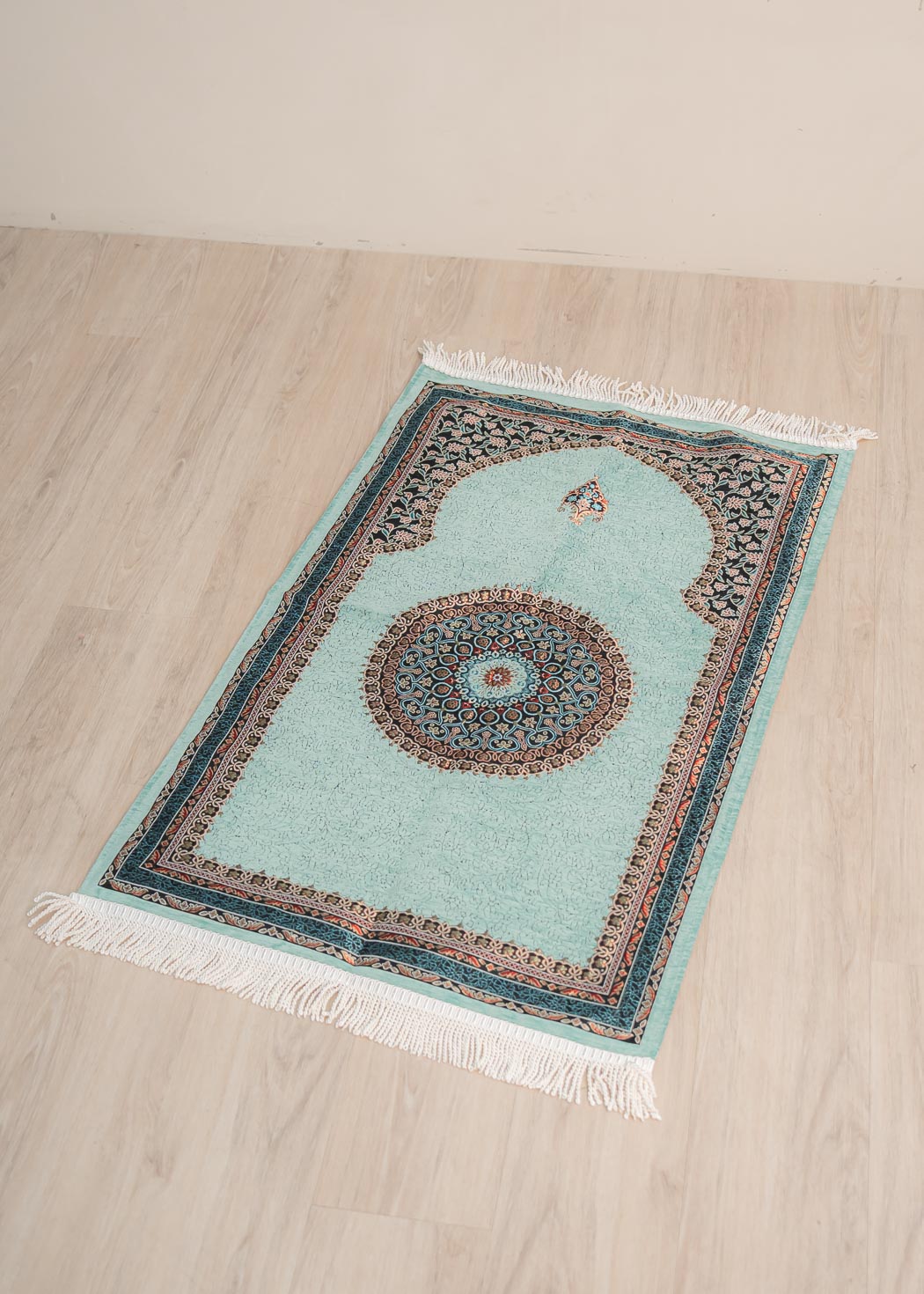 Soft cushioned prayer mat with braided fringe and traditional floral pattern 70cm x 120cm