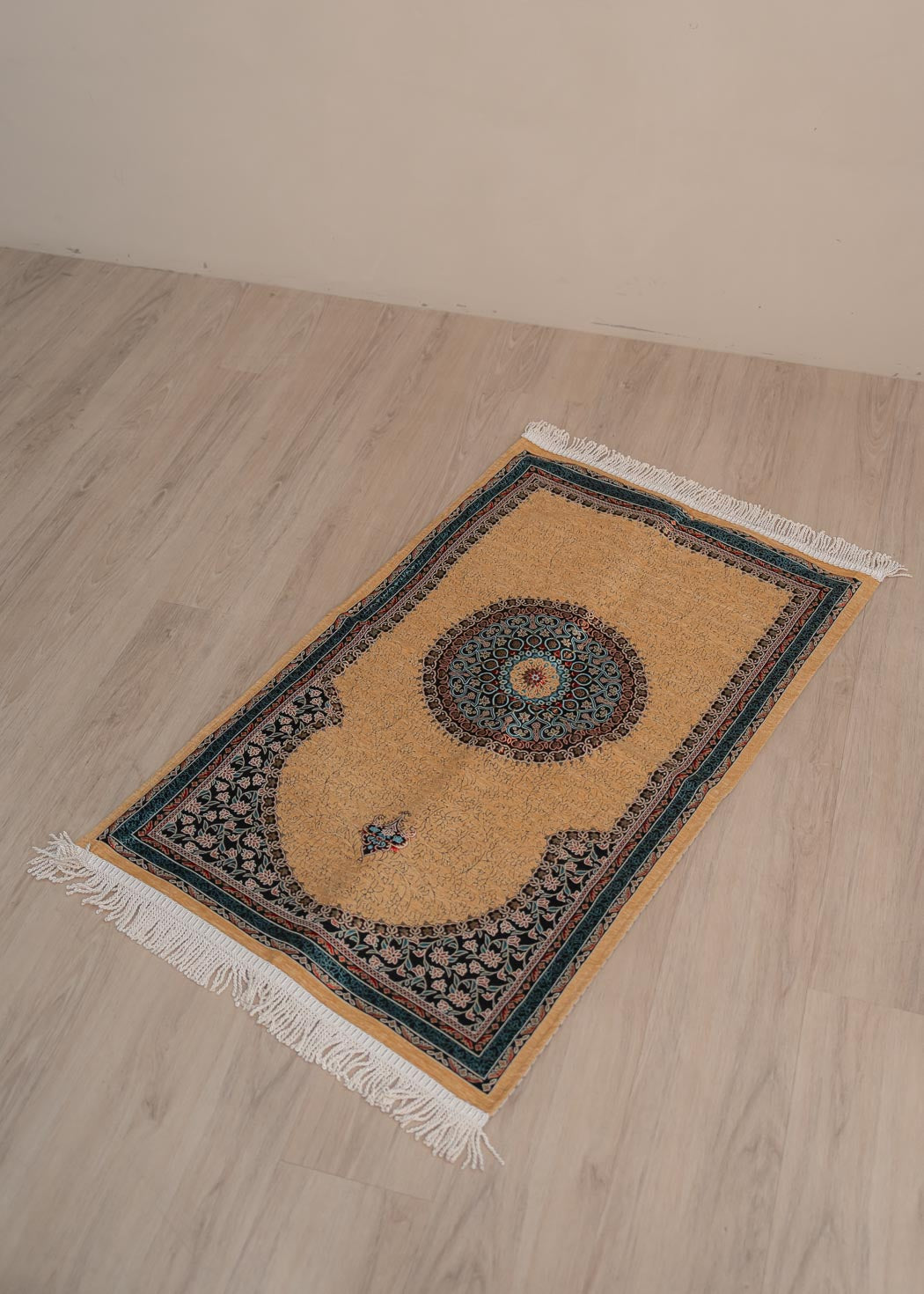 Soft cushioned prayer mat with braided fringe and traditional floral pattern 70cm x 120cm.