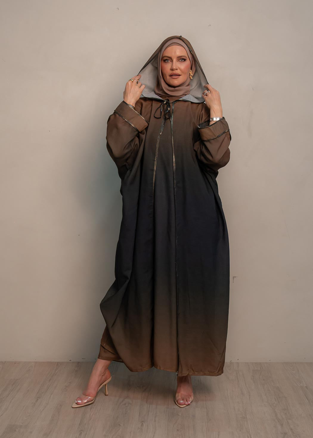 The hooded kaftan dress and tonal dress underlay provide versatility and comfort, while the lace tie neckline adds a feminine touch. Perfect for social occasions and functions, this set will be on high rotation in your wardrobe.