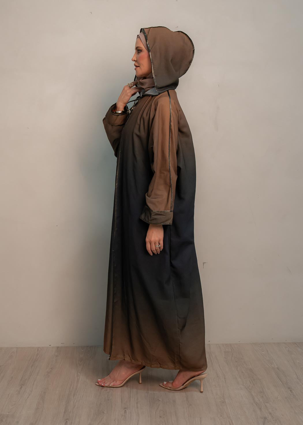 The hooded kaftan dress and tonal dress underlay provide versatility and comfort, while the lace tie neckline adds a feminine touch. Perfect for social occasions and functions, this set will be on high rotation in your wardrobe.
