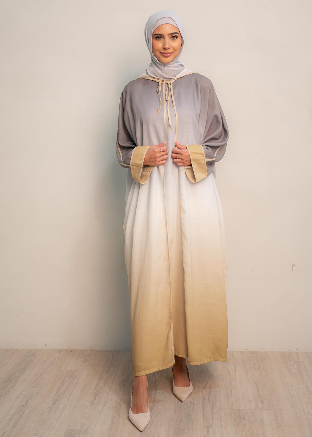 The hooded kaftan dress and tonal dress underlay provide versatility and comfort, while the lace tie neckline adds a feminine touch. Perfect for social occasions and functions, this set will be on high rotation in your wardrobe.
