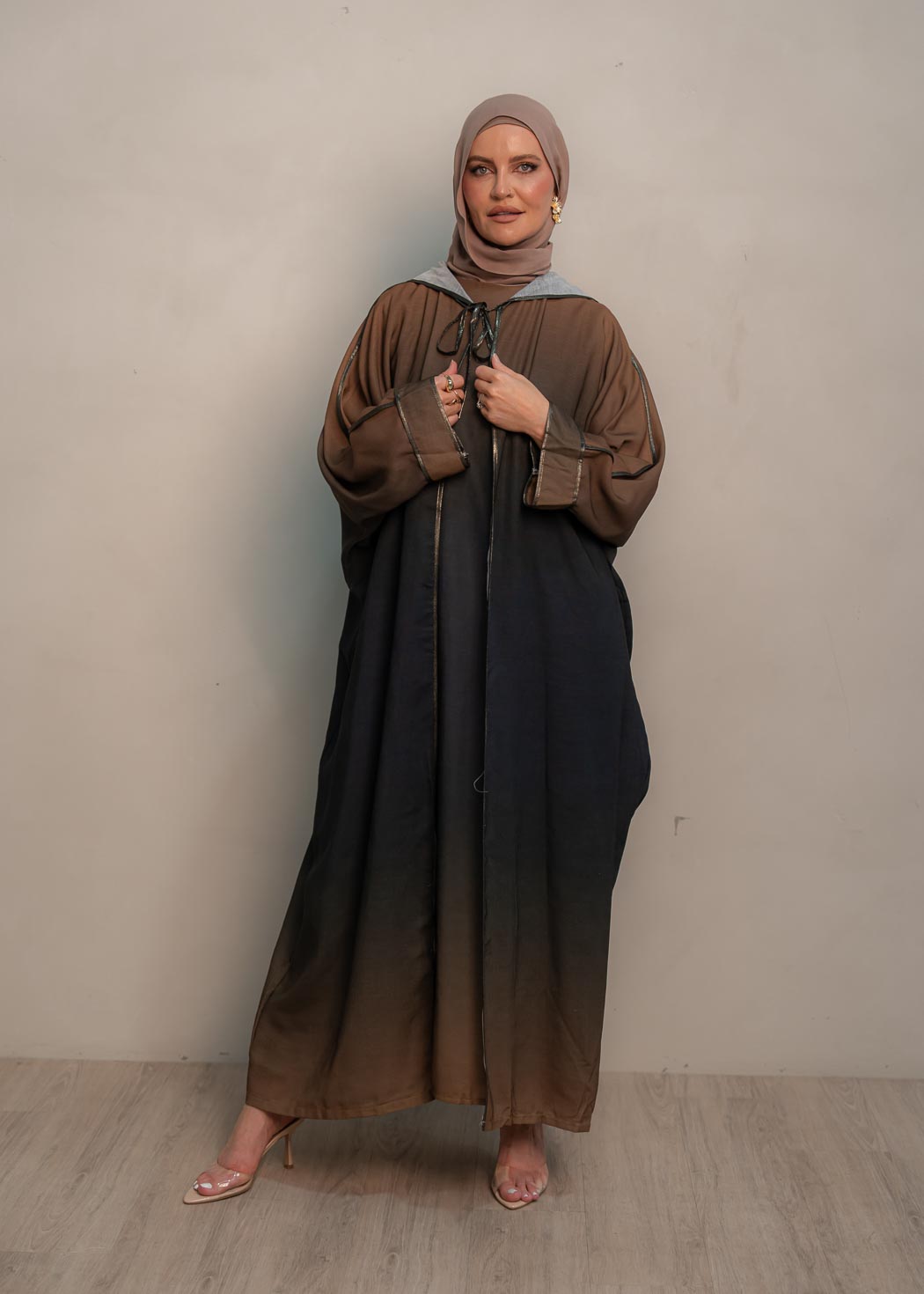 The hooded kaftan dress and tonal dress underlay provide versatility and comfort, while the lace tie neckline adds a feminine touch. Perfect for social occasions and functions, this set will be on high rotation in your wardrobe.