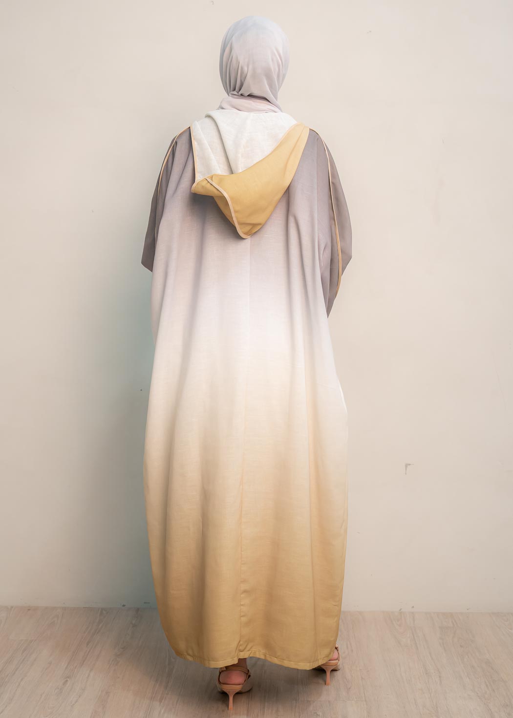 The hooded kaftan dress and tonal dress underlay provide versatility and comfort, while the lace tie neckline adds a feminine touch. Perfect for social occasions and functions, this set will be on high rotation in your wardrobe.