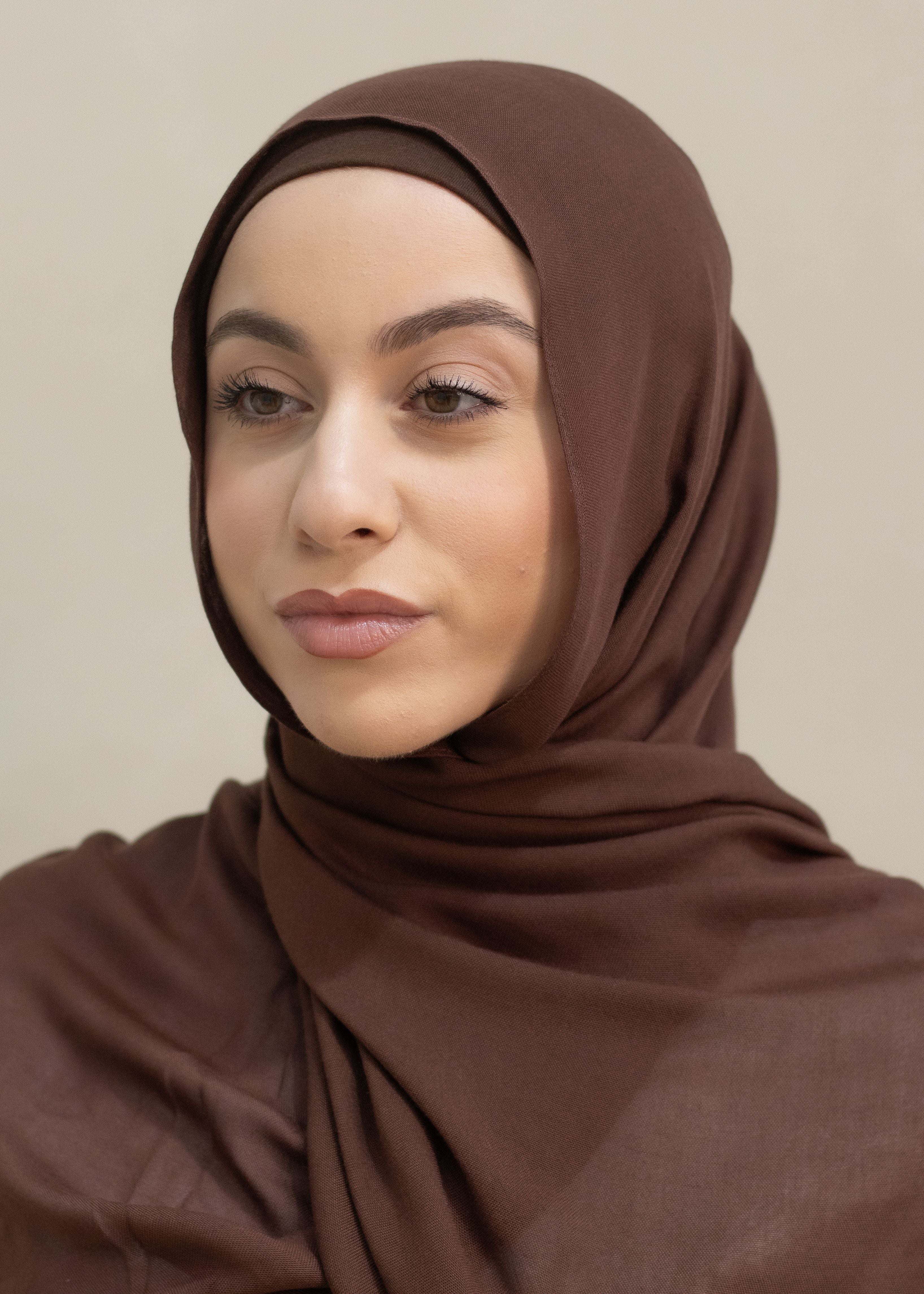 Premium Modal Hijab in a warm, spice-inspired tone, measuring 190cm x 60cm with a single stitch edge. Lightweight and breathable with a soft, elegant drape, offering near opaque coverage for comfortable everyday or occasion wear
