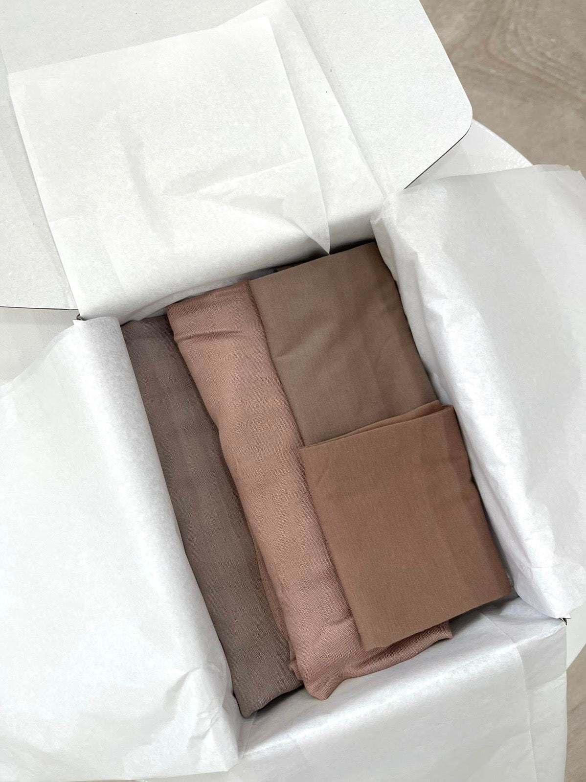 Hijab Gift Box containing 2 long Modal hijabs in Ash Rose and Fawn shades, paired with 2 caps. A thoughtful gift for Eid, Mother's Day, or someone new to wearing the hijab