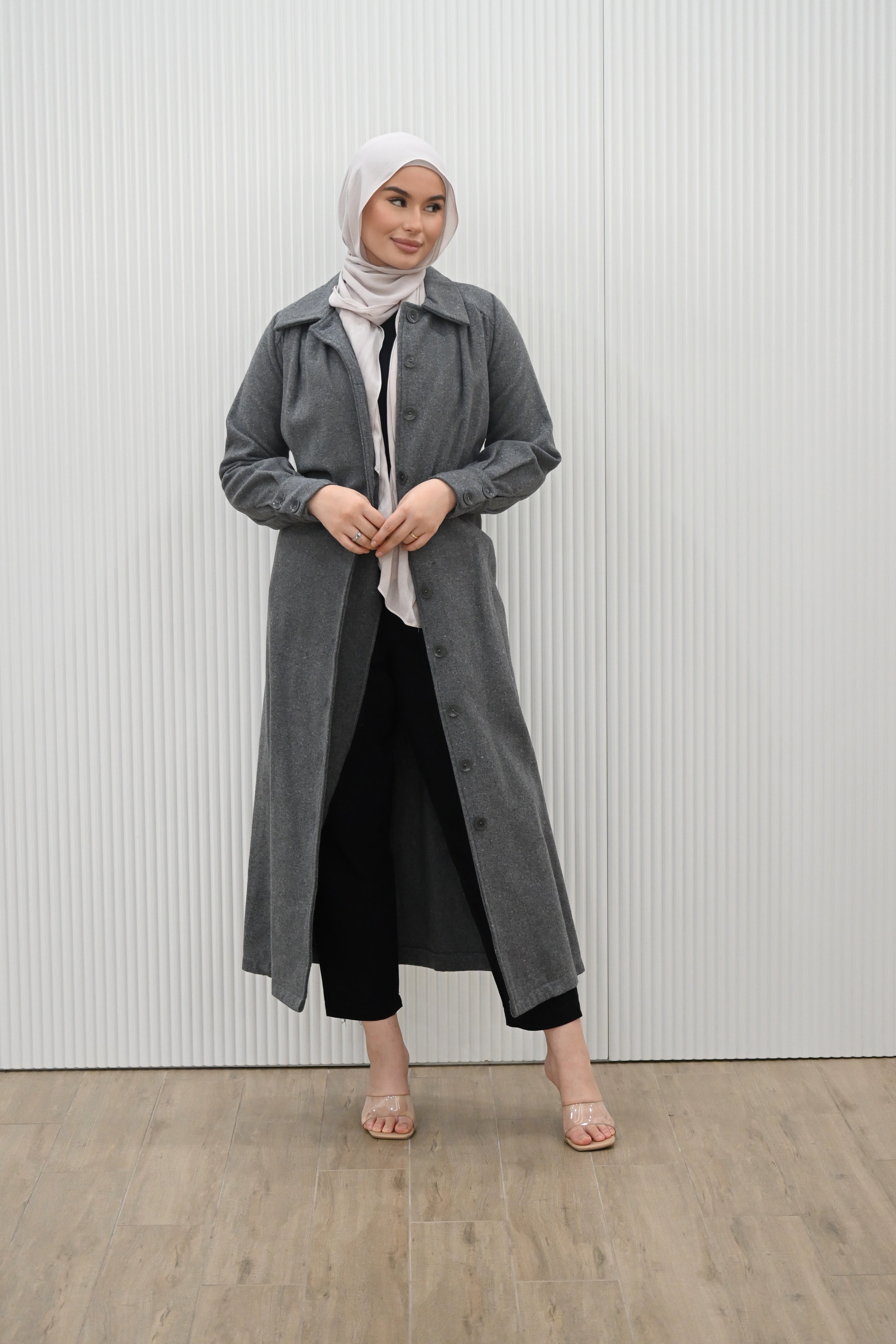 This buttoned maxi coat not only exudes elegance, but also offers practicality with a detachable waist tie for a fitted look. The wide collar and long sleeves with buttoned cuffs complete the full length silhouette, keeping you warm and stylish all season long.