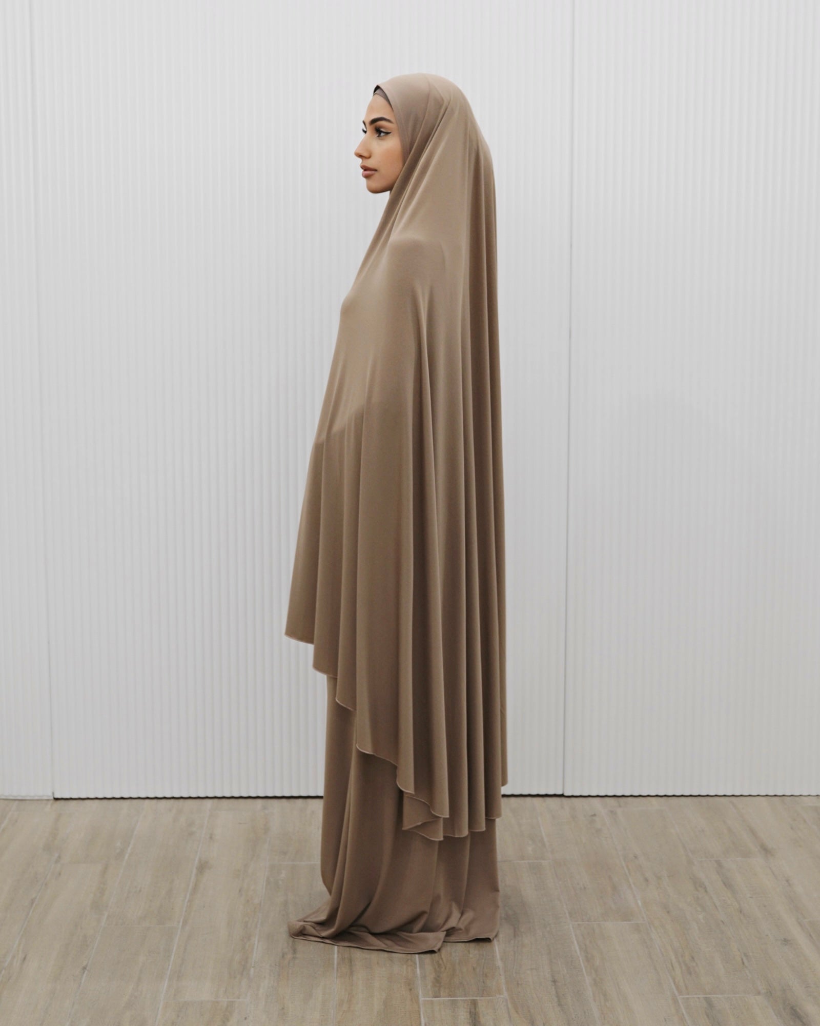 Signature prayer set in a loose, comfortable fabric, featuring a large mocha jilbab and a matching floor-length skirt for full coverage and ease of movement.