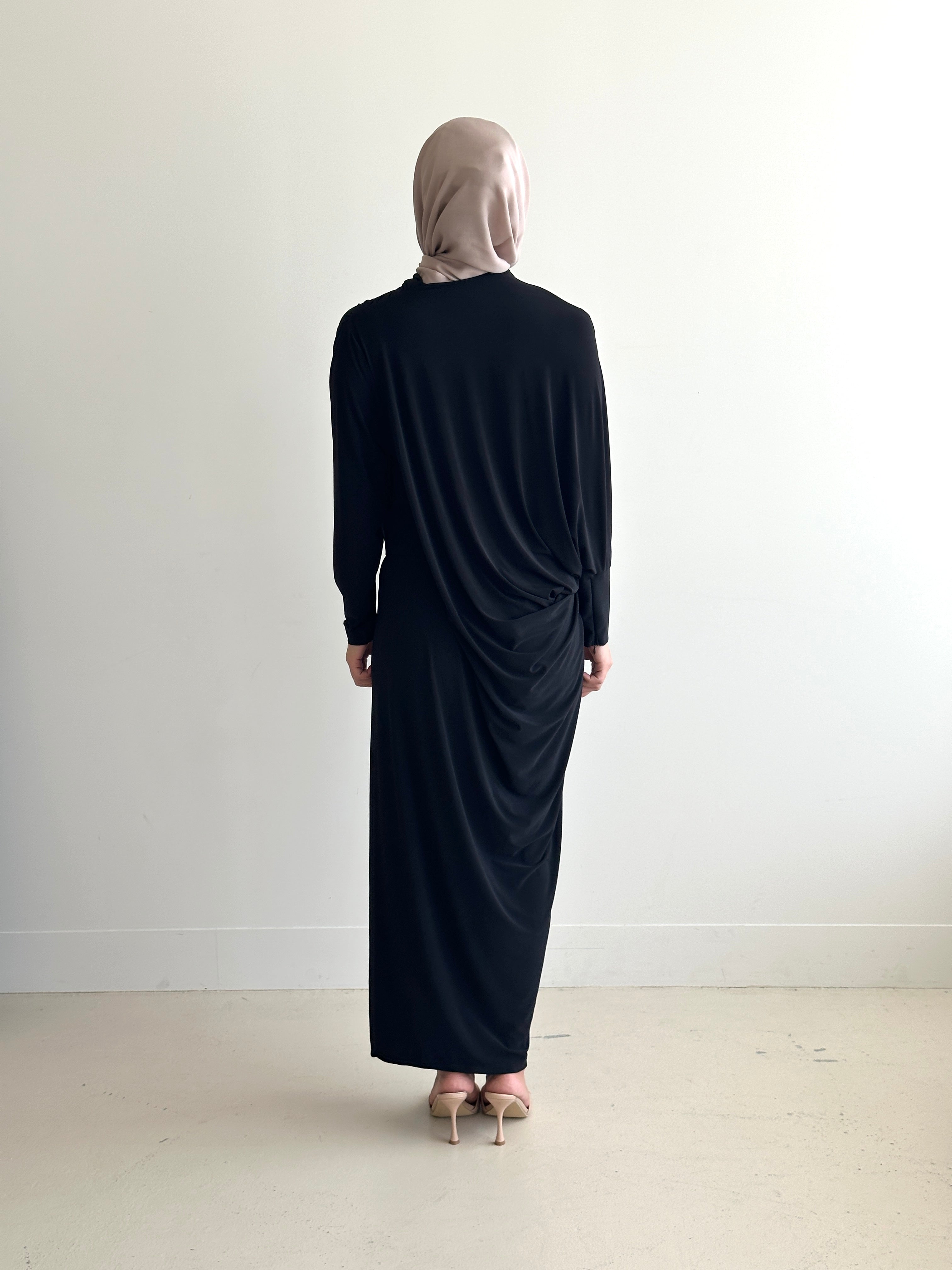 Crafted from a soft, breathable jersey fabric, this dress drapes beautifully over the silhouette while offering stretch and movement that feels as comfortable as it looks.