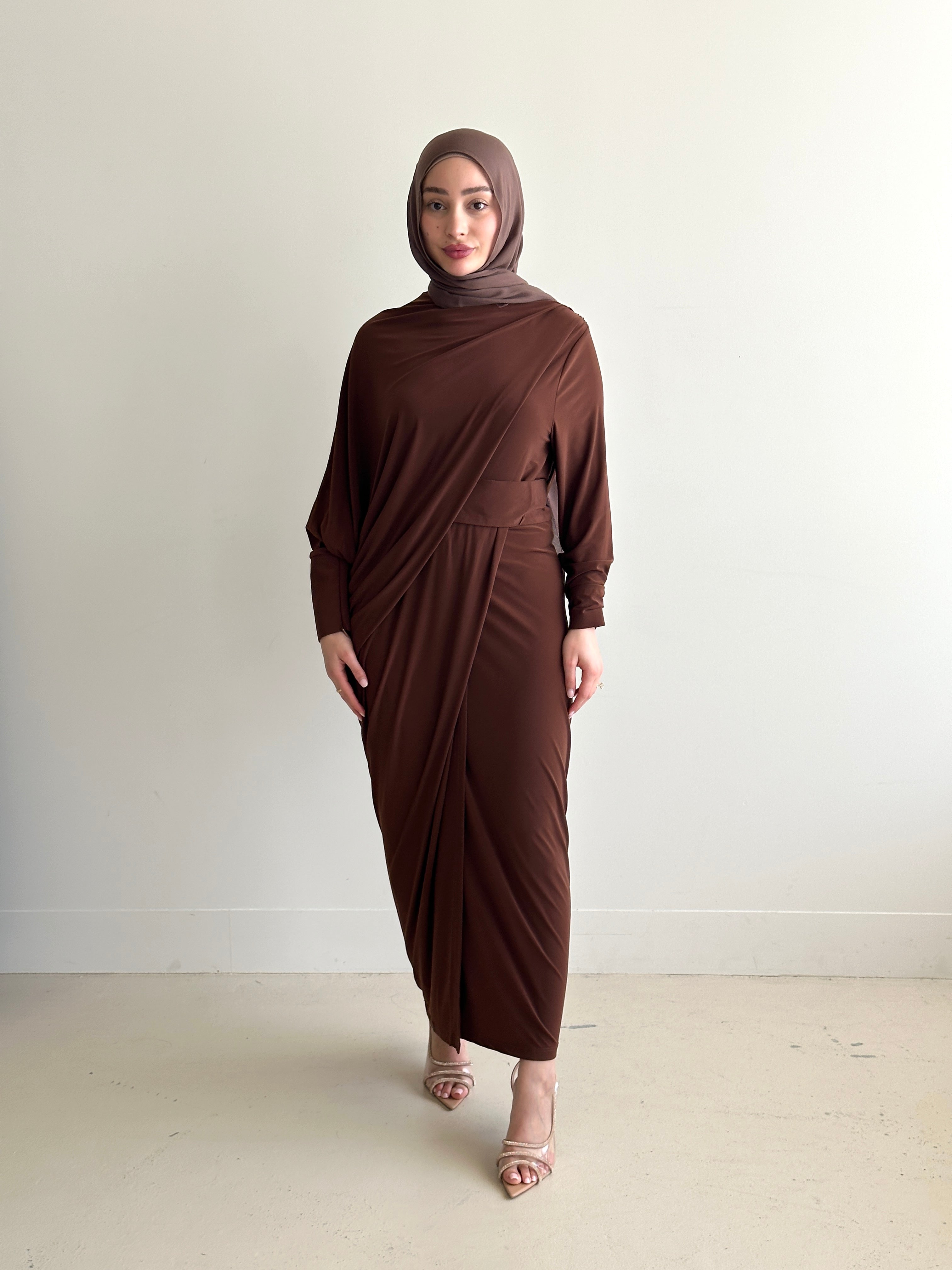 Crafted from a soft, breathable jersey fabric, this dress drapes beautifully over the silhouette while offering stretch and movement that feels as comfortable as it looks.