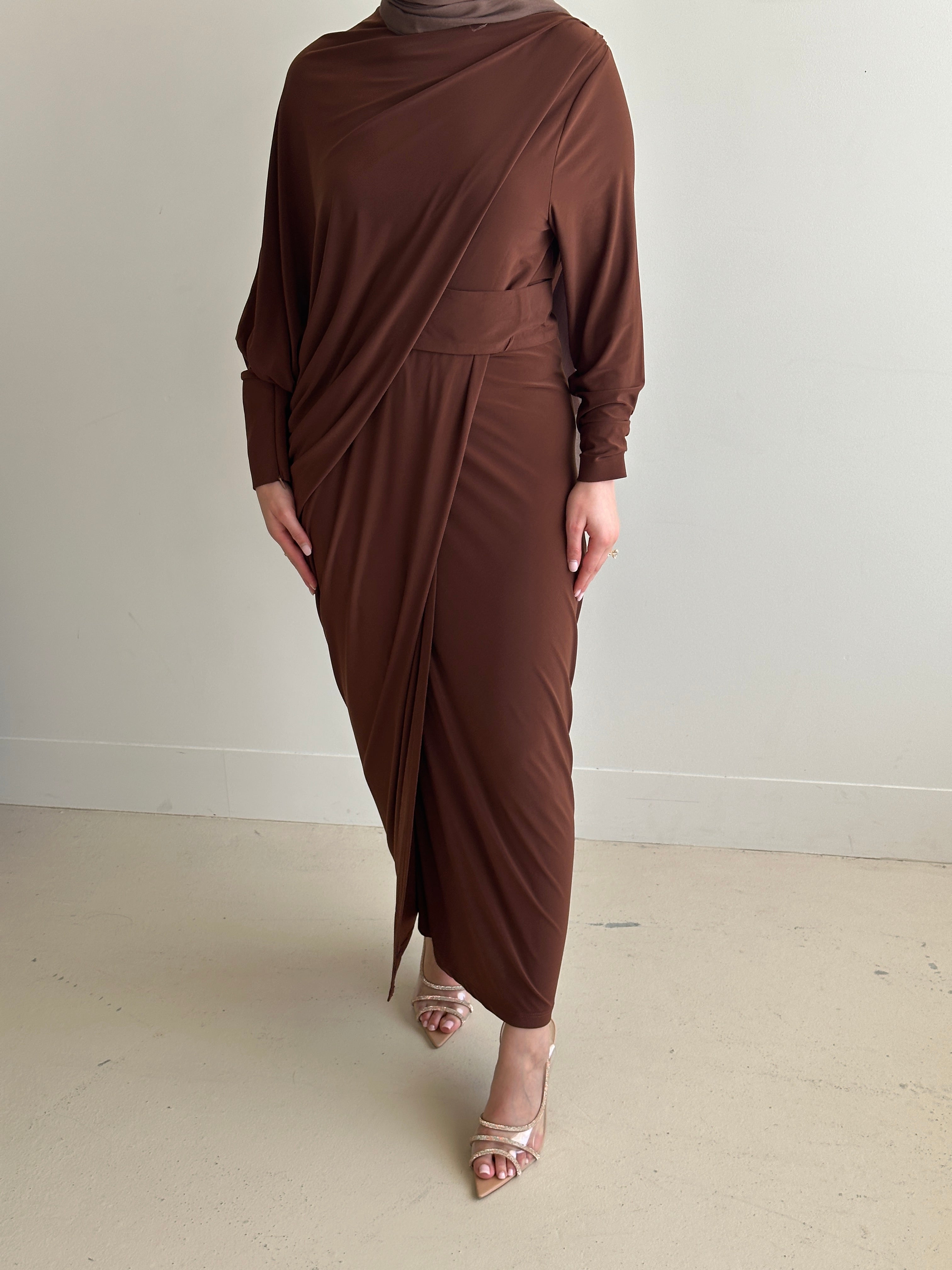 Crafted from a soft, breathable jersey fabric, this dress drapes beautifully over the silhouette while offering stretch and movement that feels as comfortable as it looks.